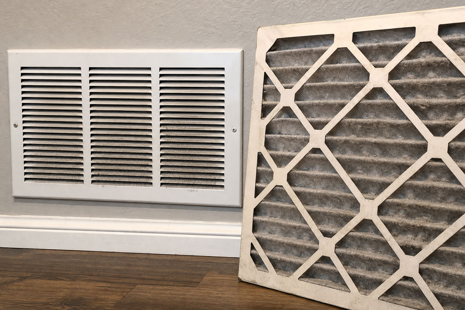 Dirty HVAC air filter and return vent showing a common airflow restriction