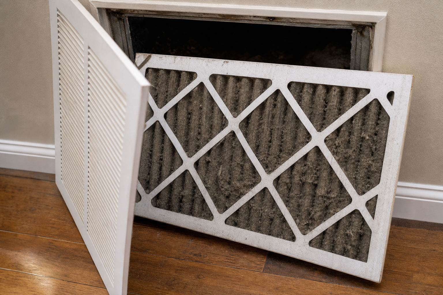 Dirty HVAC air filter being removed for inspection