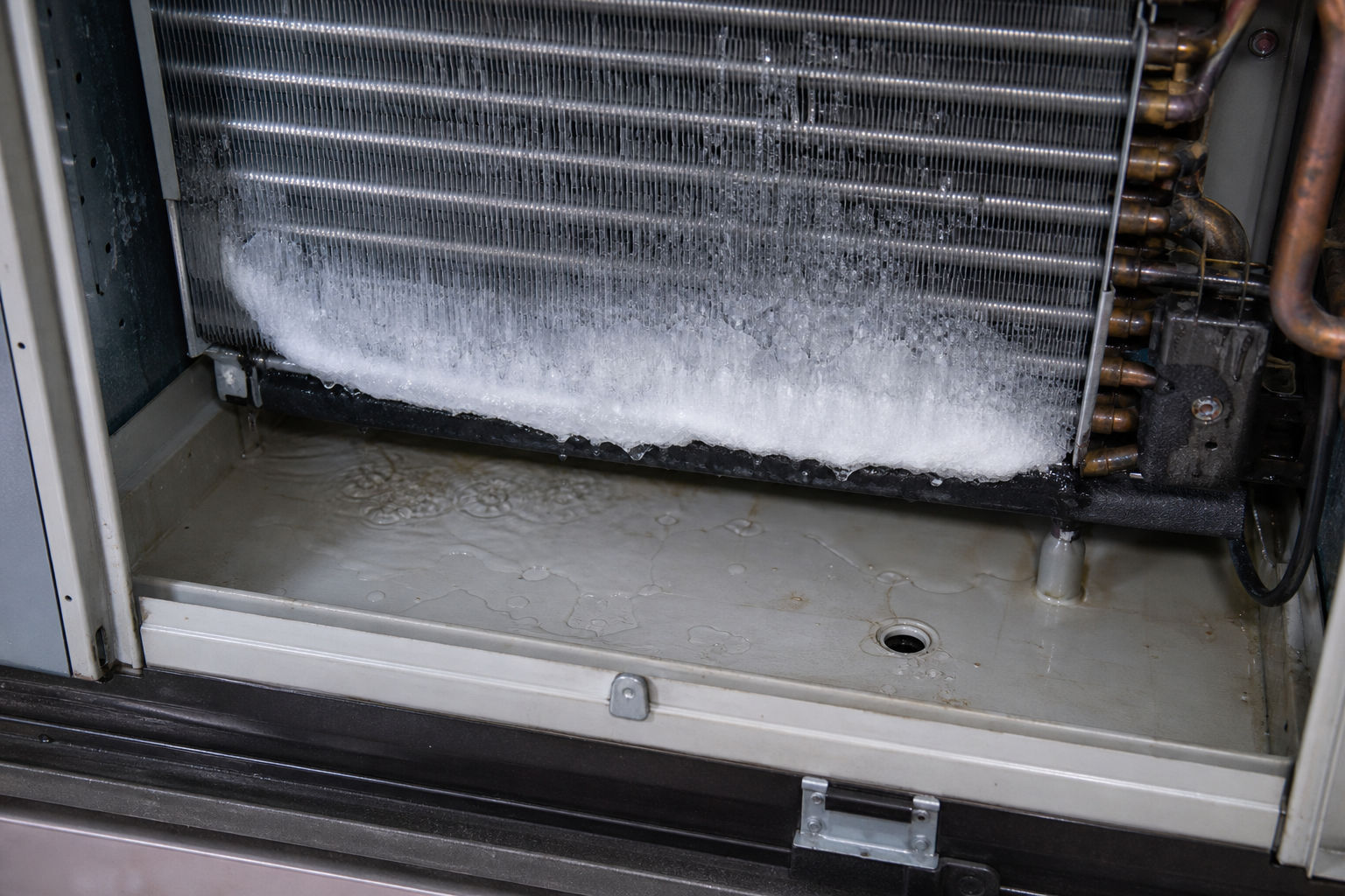 Frozen evaporator coil that can lead to indoor AC water leaks when thawing