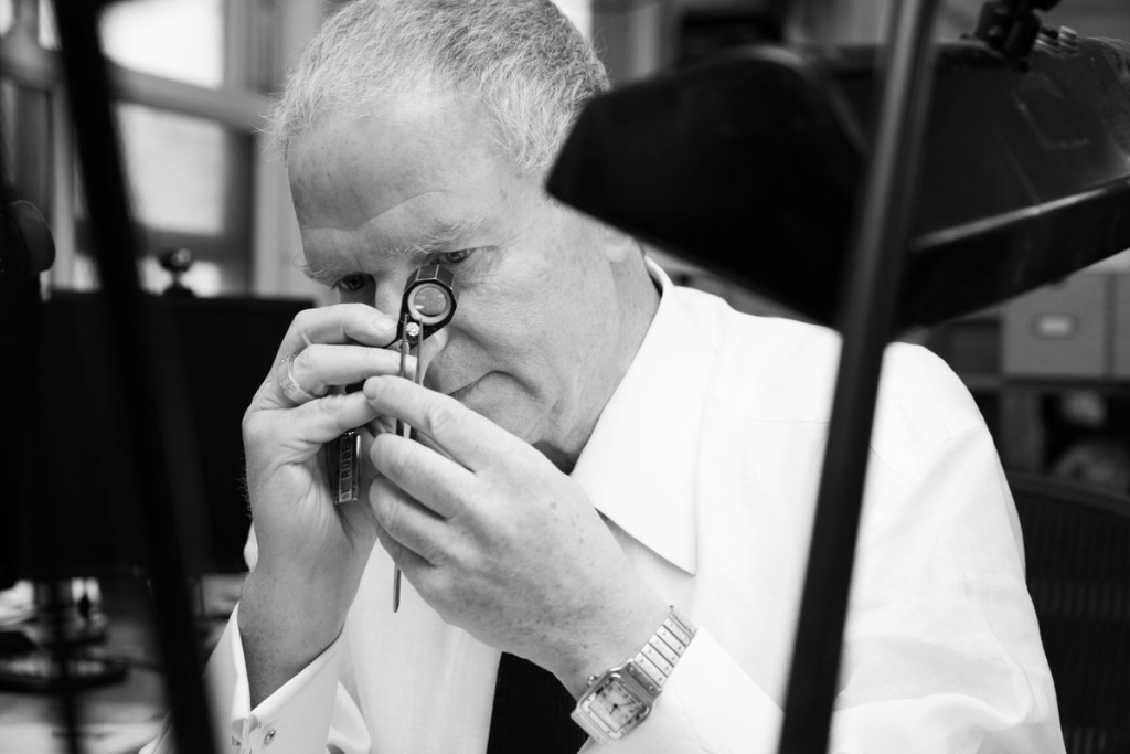 Diamond expert examining a princess cut diamond