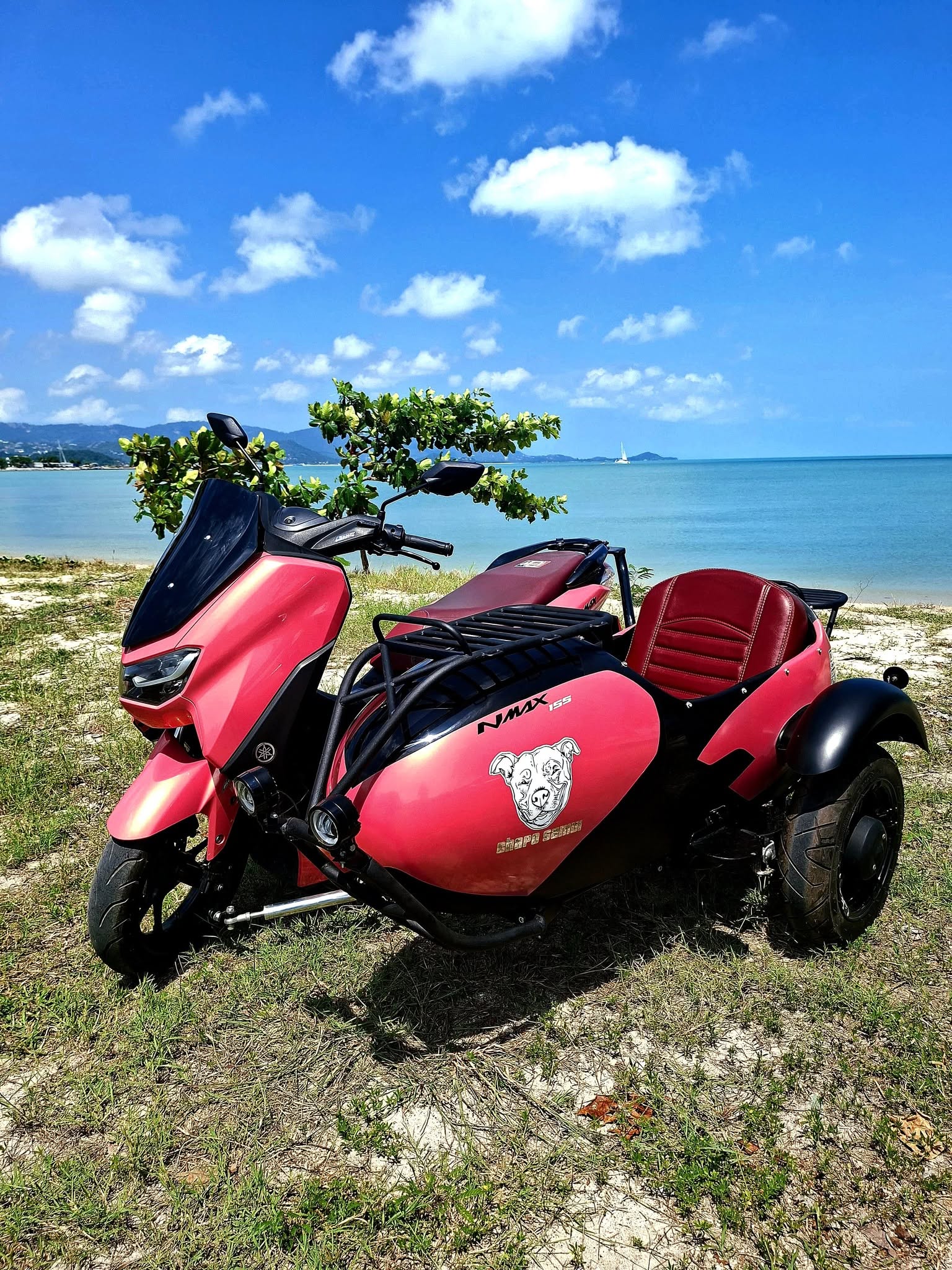 Red Chapo Samui sidecar motorcycle parked on a beach in Koh Samui