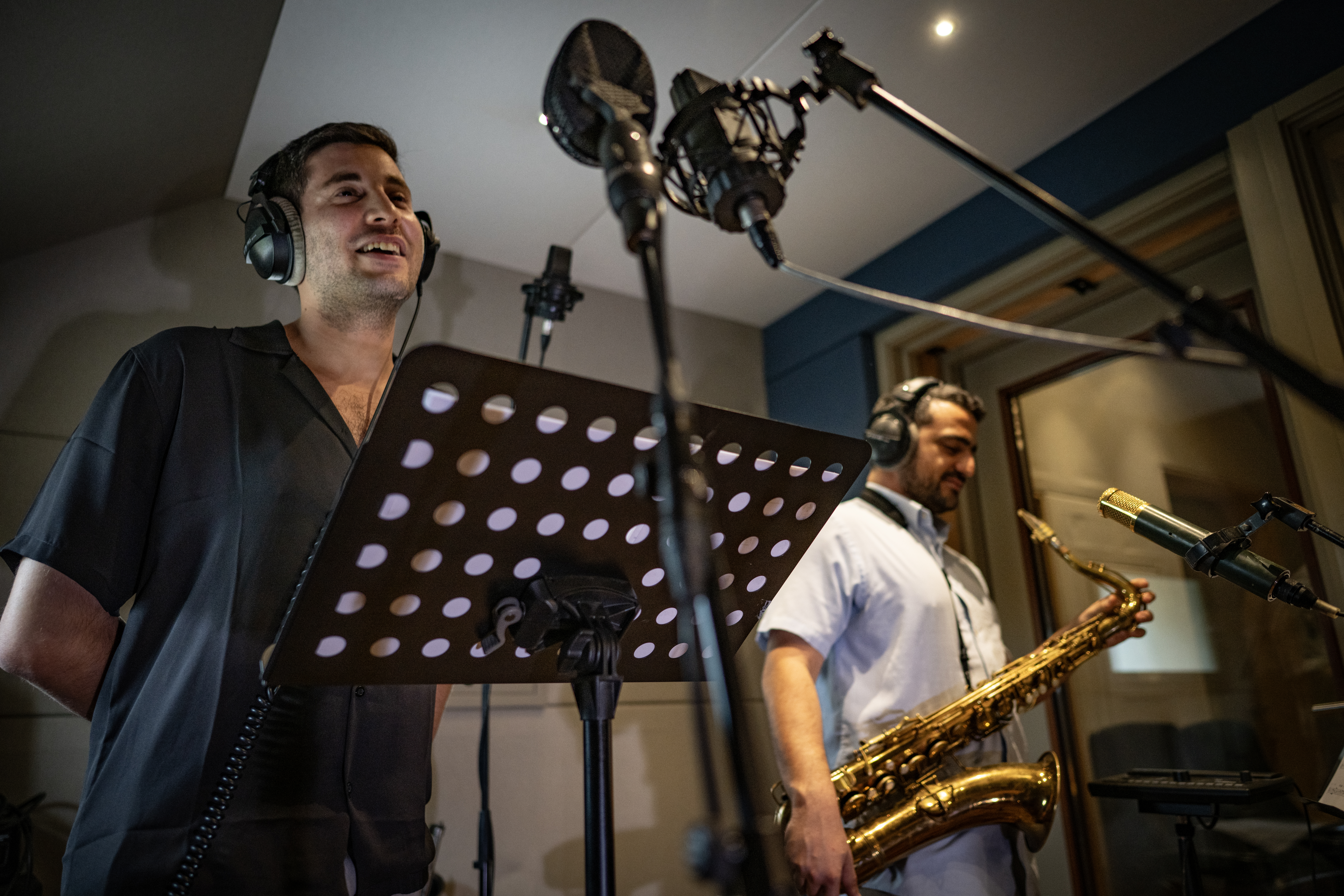 The horn players sharing a relaxed moment between takes.