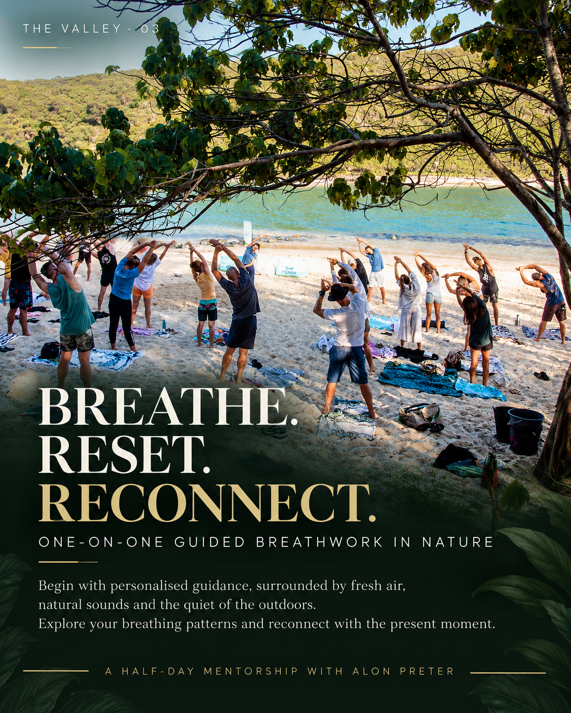 A group on the sand with arms raised in guided breathwork beside the ocean