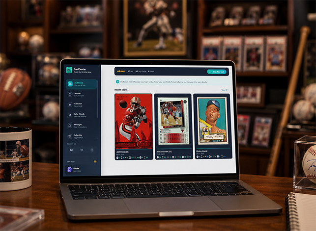A sports card centering tool interface displayed on a laptop at a wooden collector's desk, with recent sports card scans visible including a red football player card and vintage cards, surrounded by baseballs, a coffee mug, and blurred framed sports memorabilia on shelves in the background.