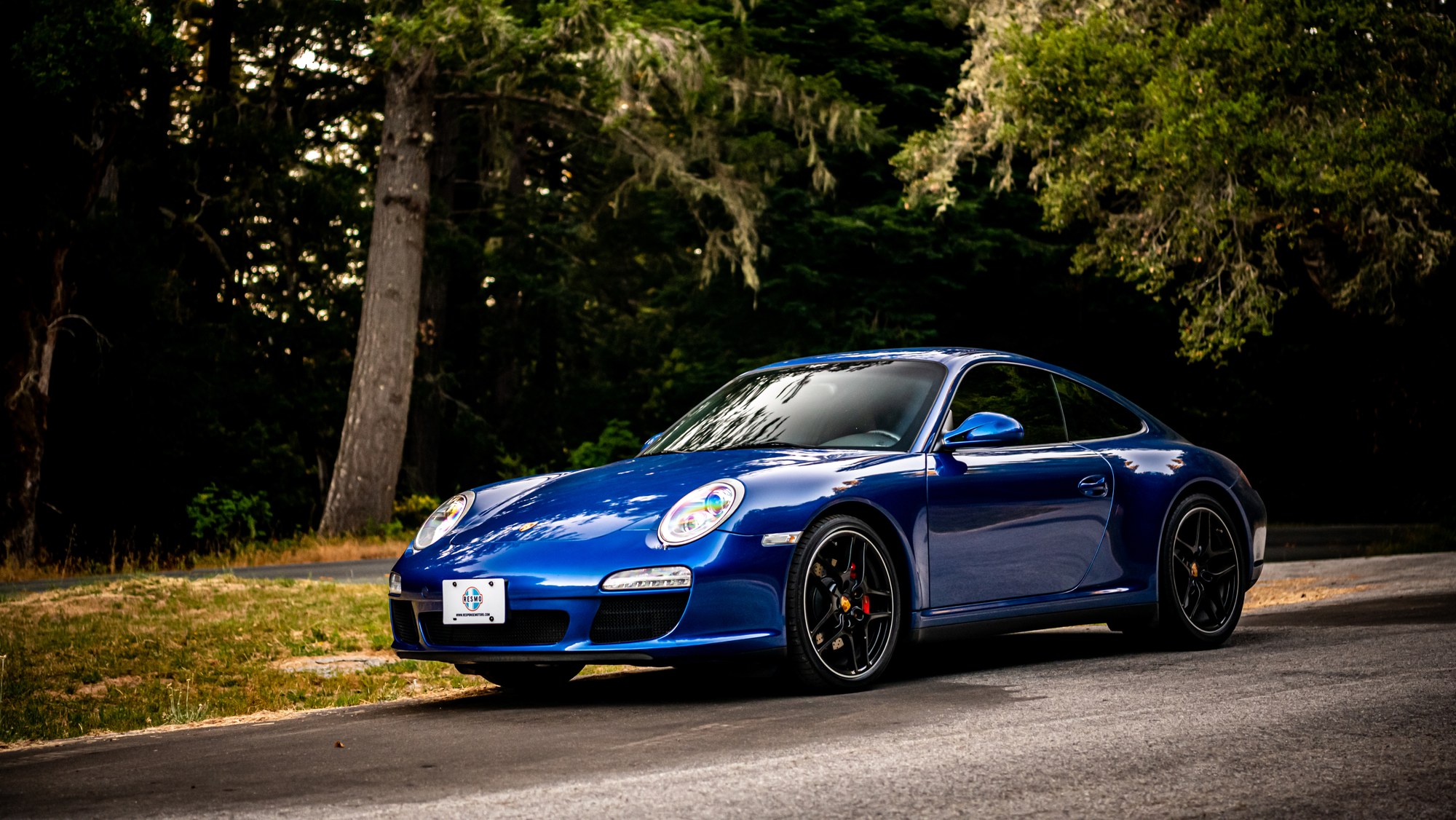 Porsche 911 C4S headlight detail in blue, automotive detail photography by Sharplite Media, Bay Area