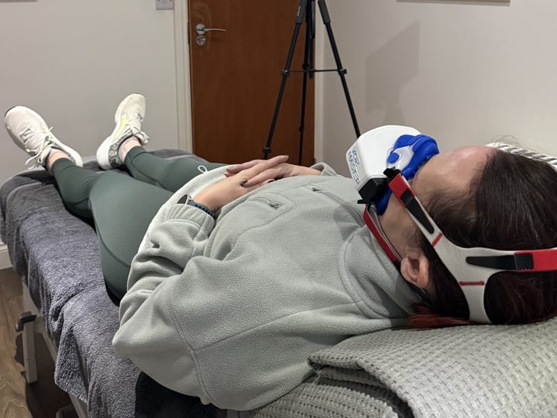 Client lying down during a resting metabolic rate test, breathing through the mask