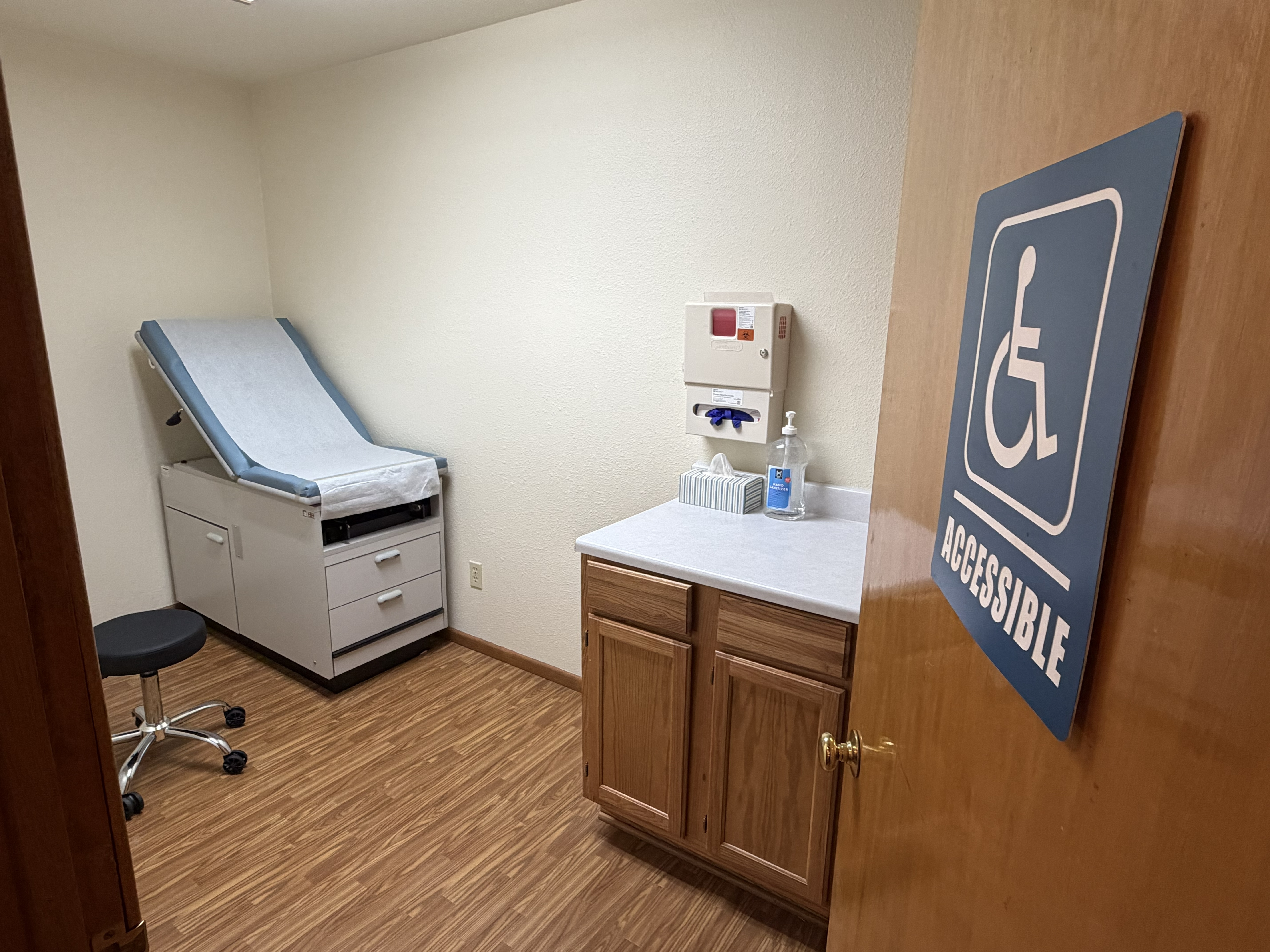 Wellspring Healthcare exam room with accessibility signage