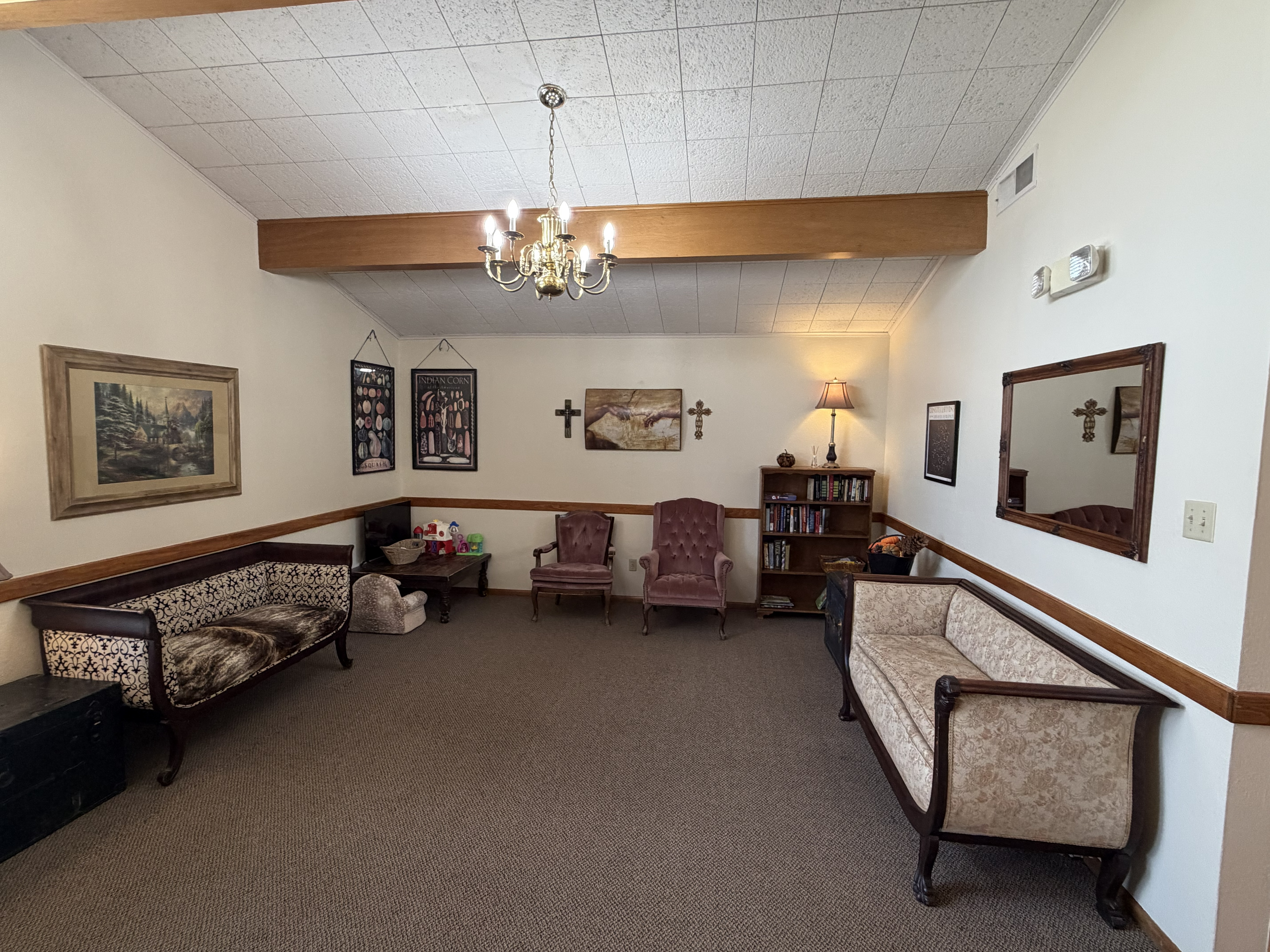 Wellspring Healthcare reception area with bookcase, seating, and botanical artwork