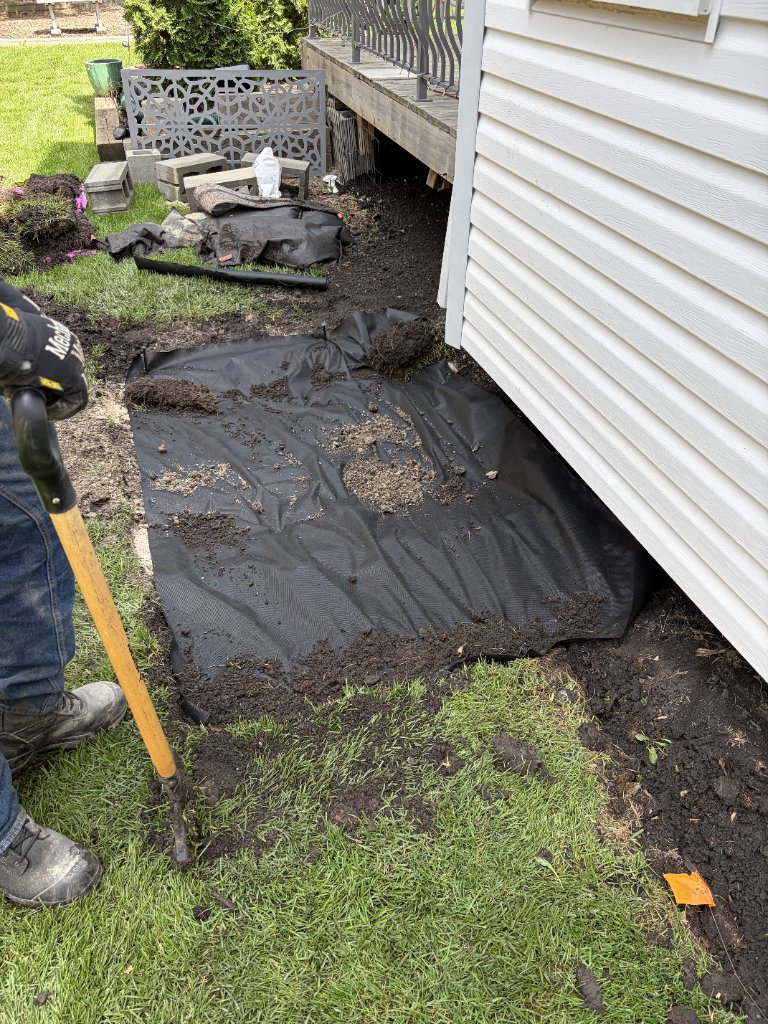 Backyard drainage project — 2 drainage channels running away from the house installed, grade adjusted away from home and fabric put on top — MW Construction and Landscaping in Edmonton & Beaumont, Alberta