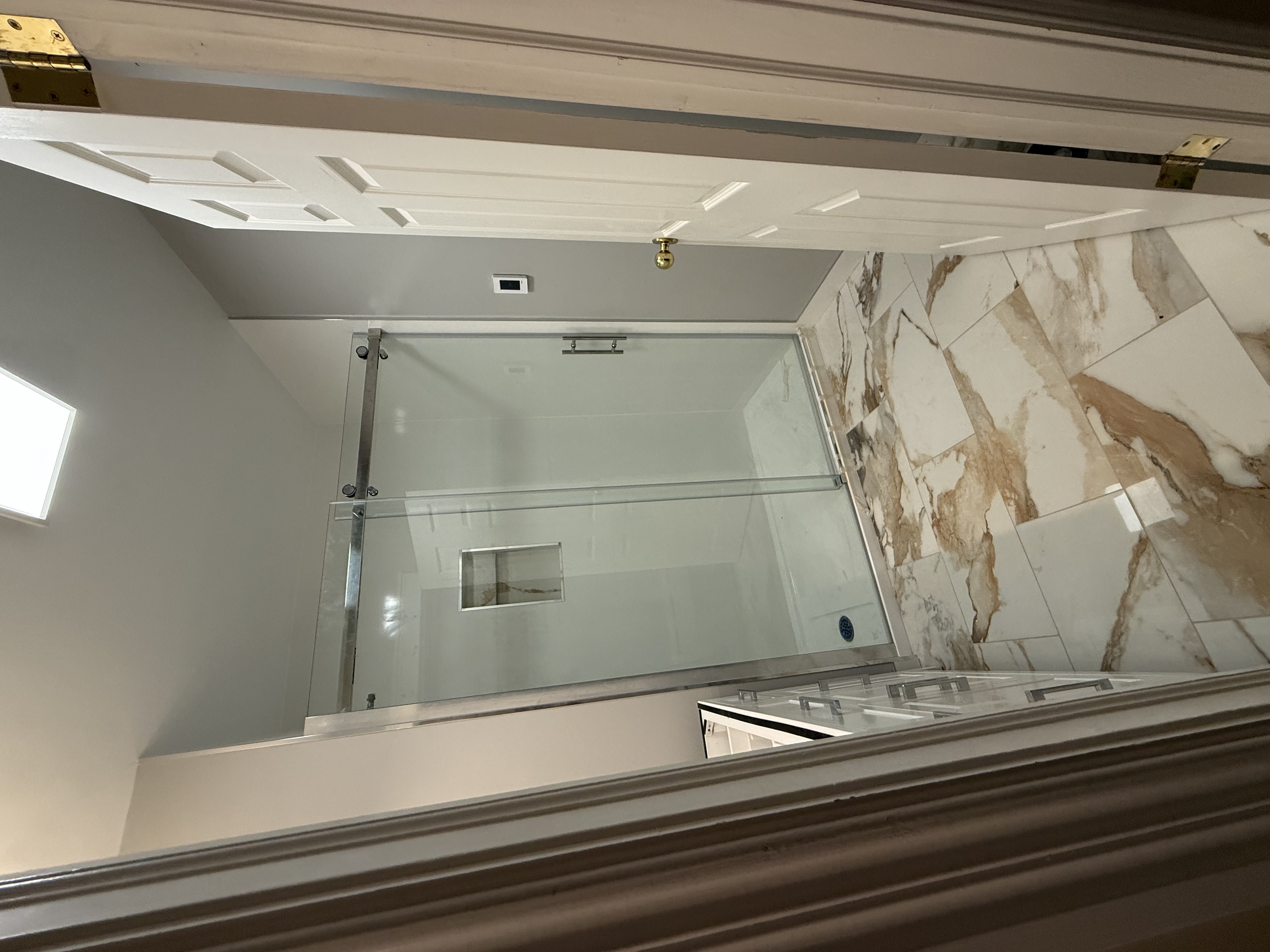 Bathroom with walk-in shower and marble floor tiles — VP ReNewWay Mount Pearl NL