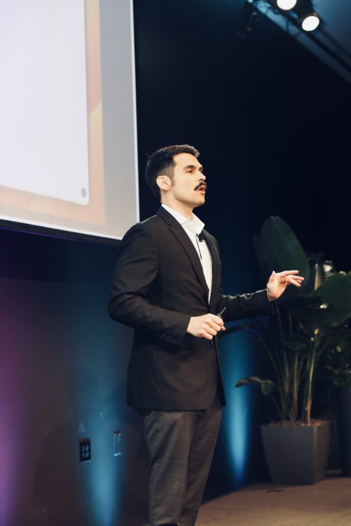 Topher Stephenson presenting on stage at a commercial real estate conference