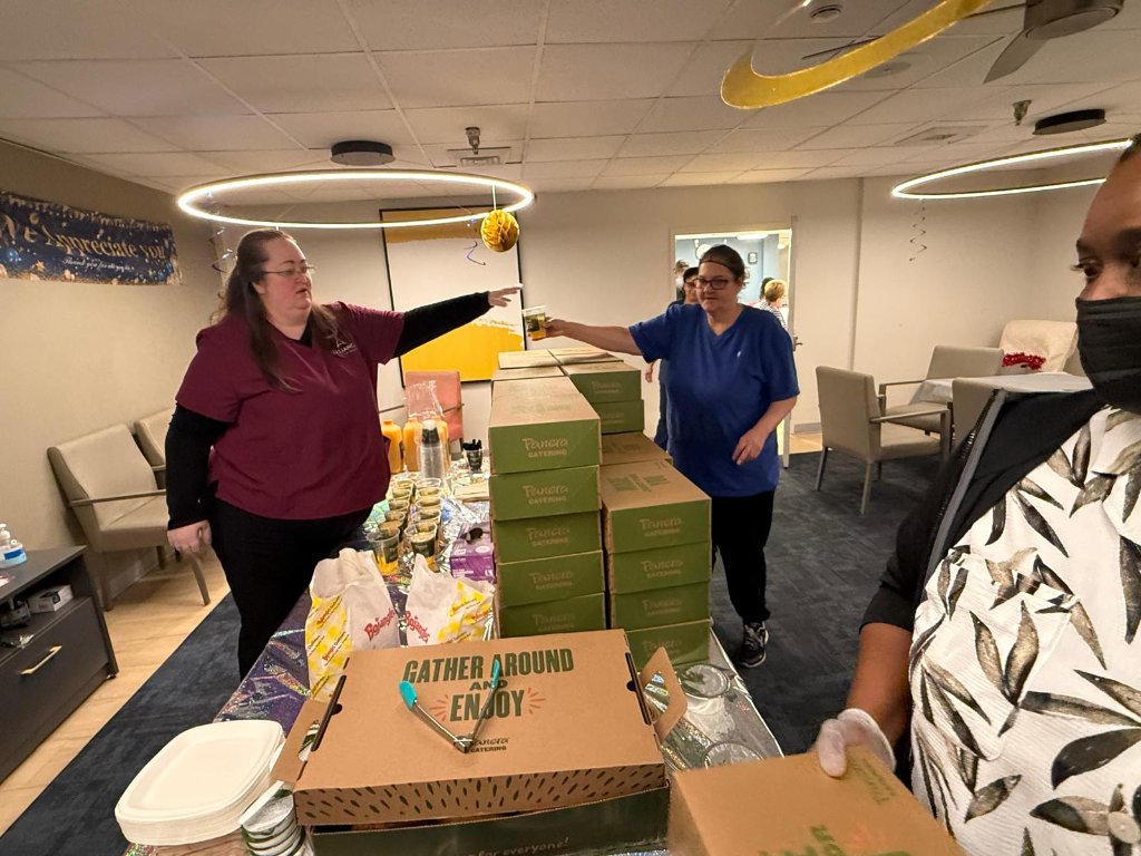 Staff setting up catering boxes for employee appreciation week