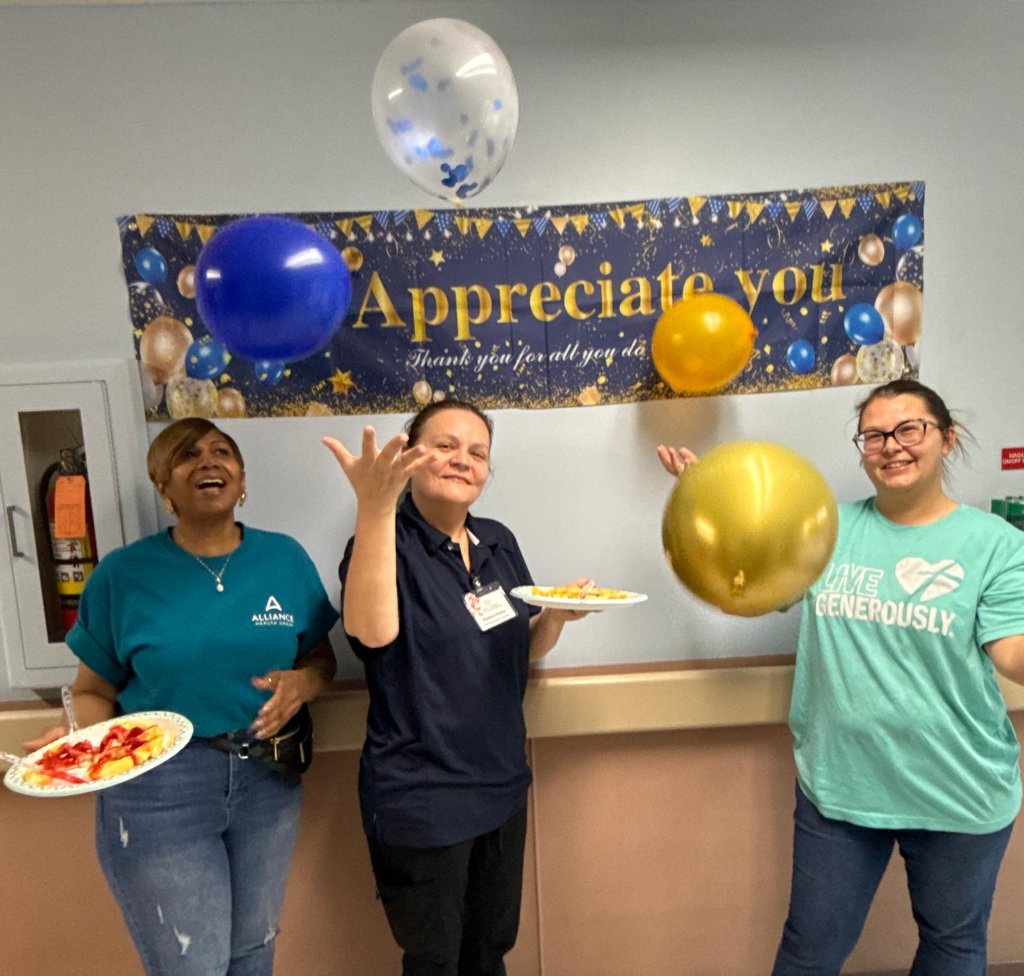 Staff celebrating with balloons at appreciation event