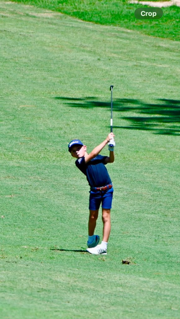 Jones brother follow-through on a sunlit fairway
