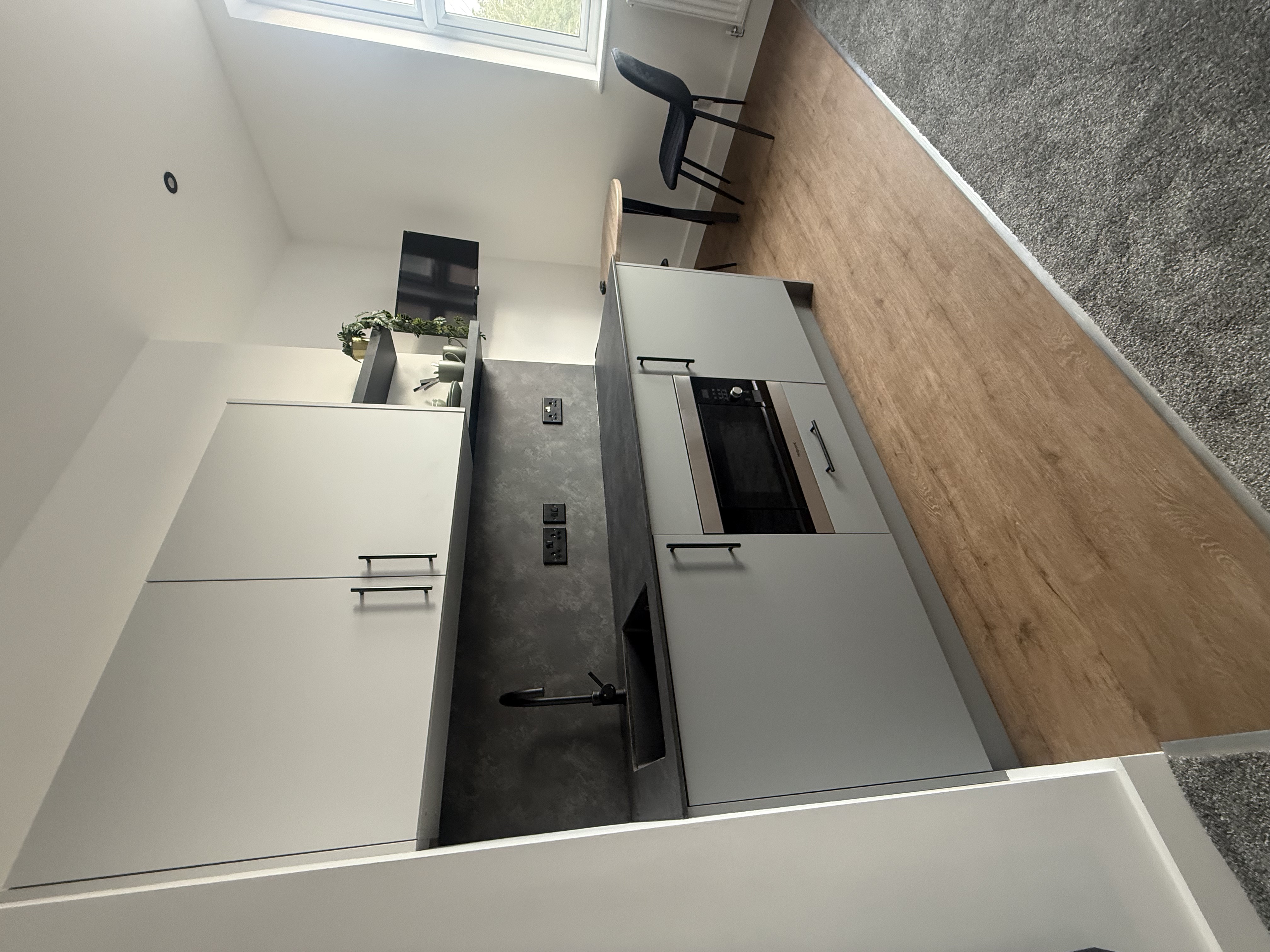 Two-tone kitchenette with black fittings