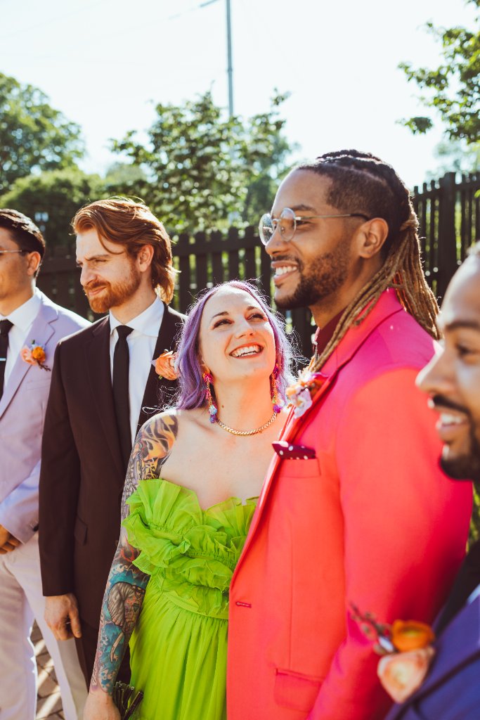 A wedding party standing outdoors