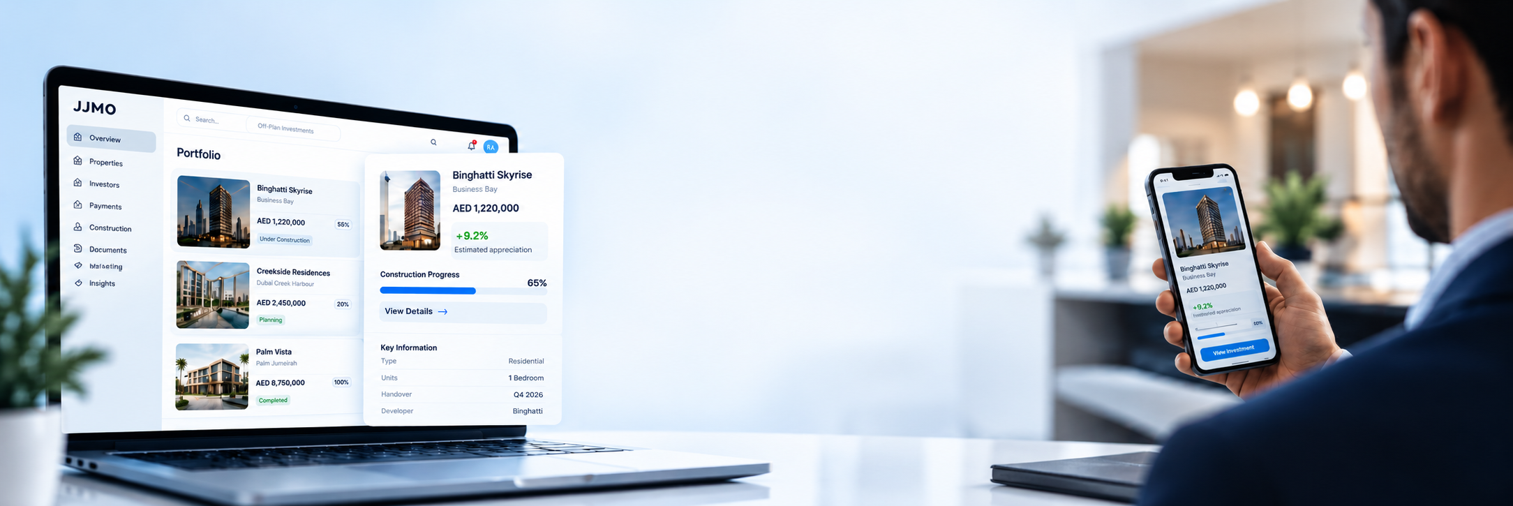Investor experience — JJMO portfolio dashboard on a laptop and phone in a bright office