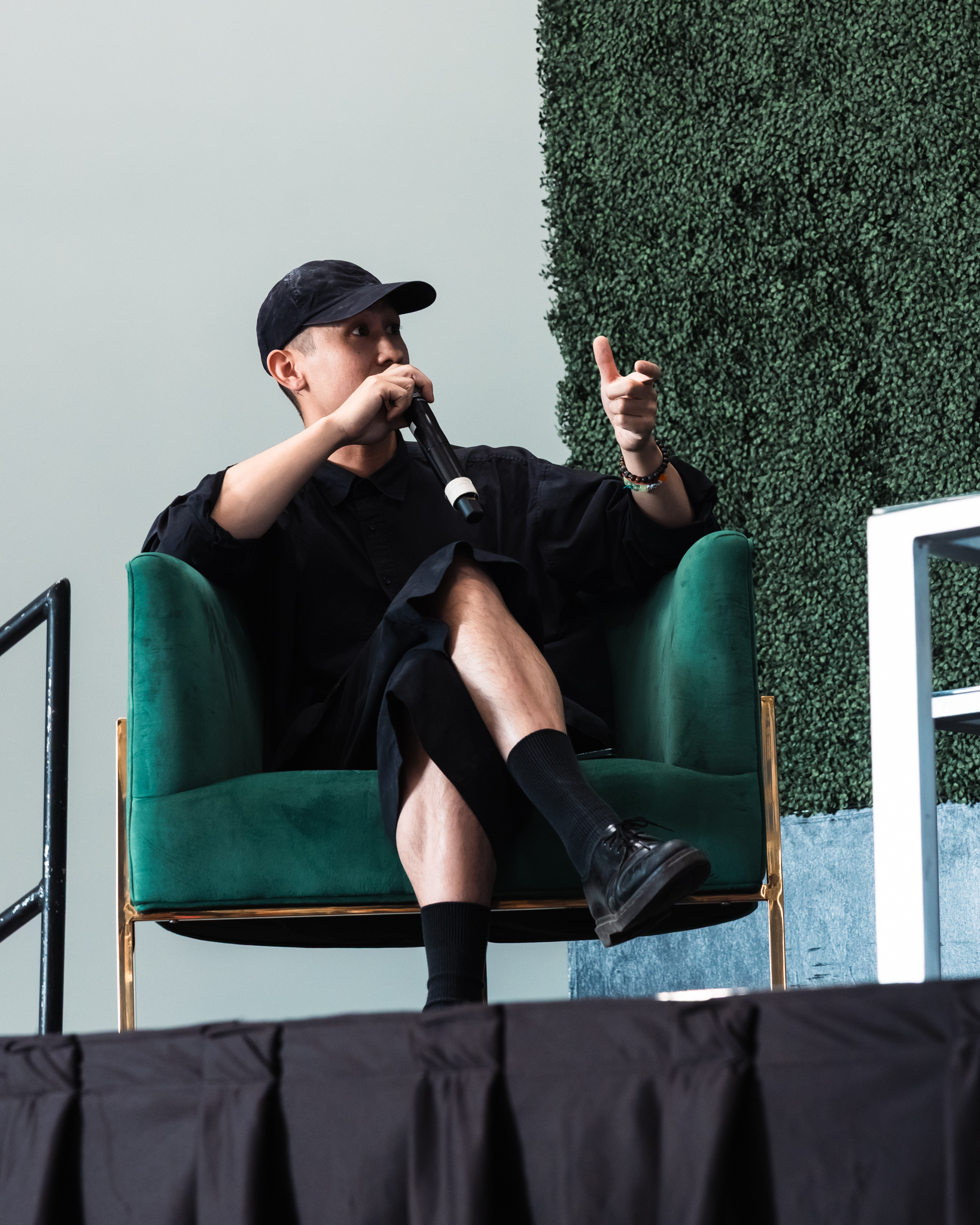 Panelist in a black cap speaking into a microphone on the Network Show stage