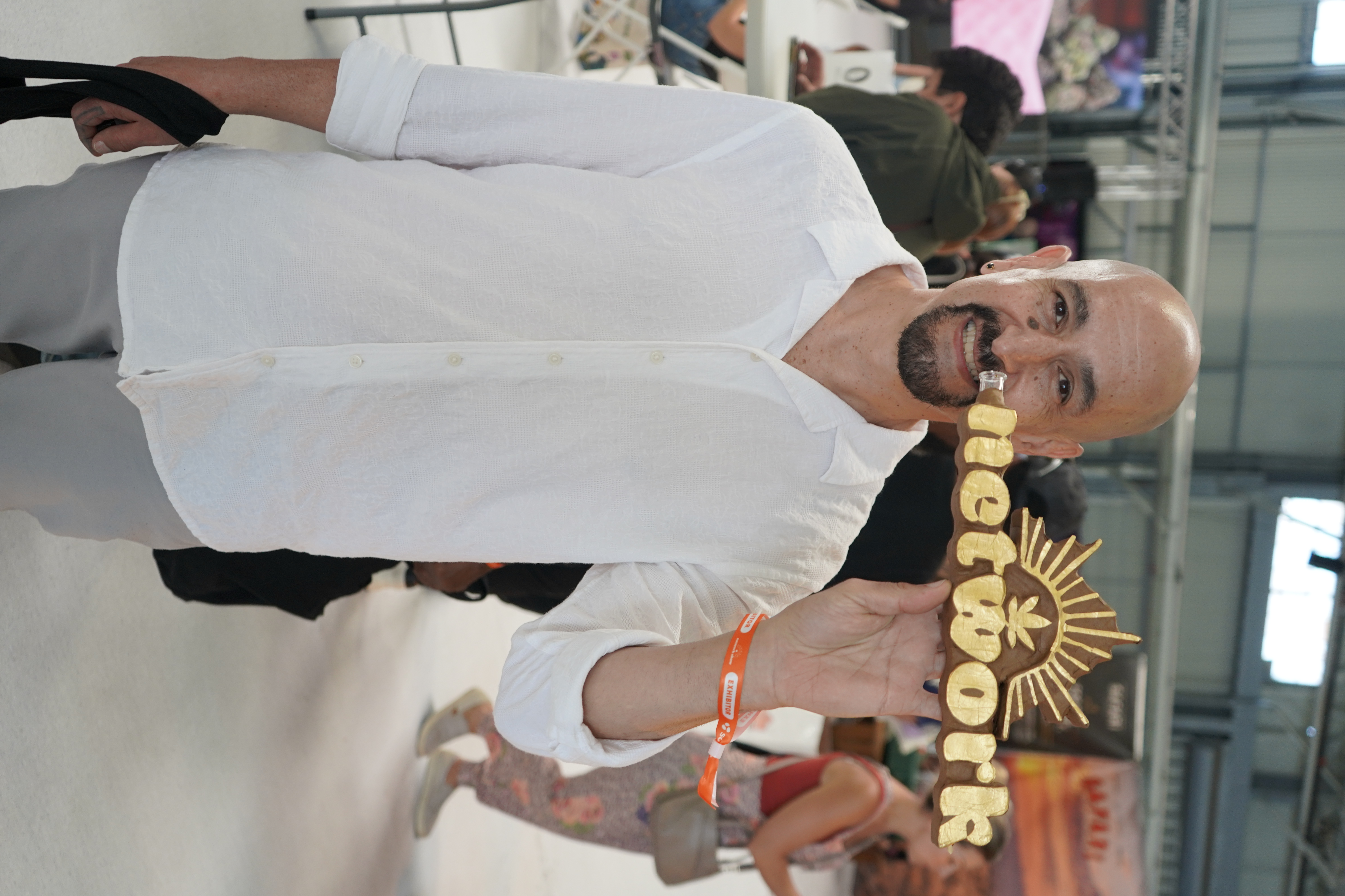 Attendee holding a Network Show sign at the event