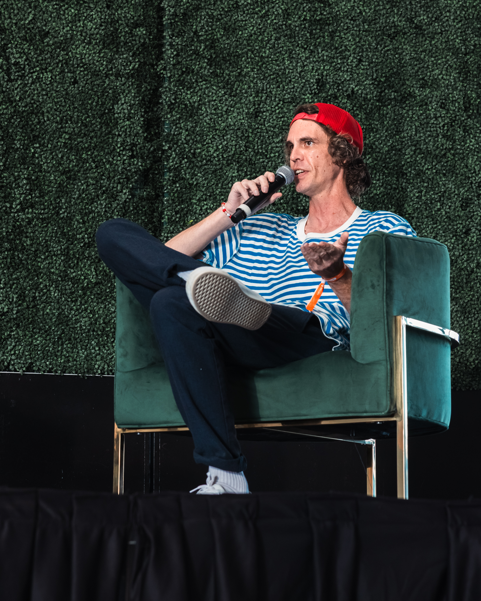 Speaker with a microphone on stage during the AI in Cannabis panel