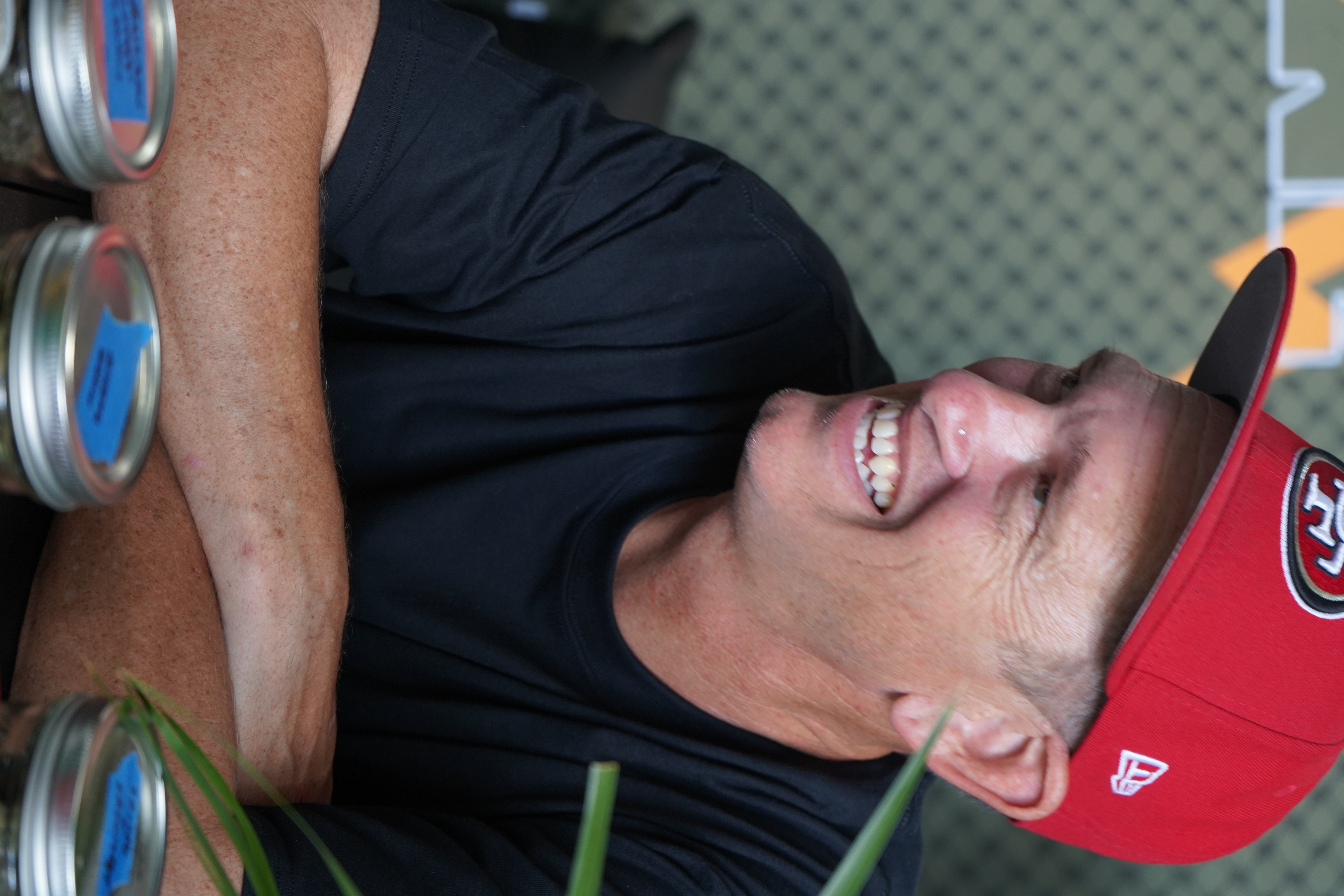 Smiling attendee in a red cap at Network Show 2026