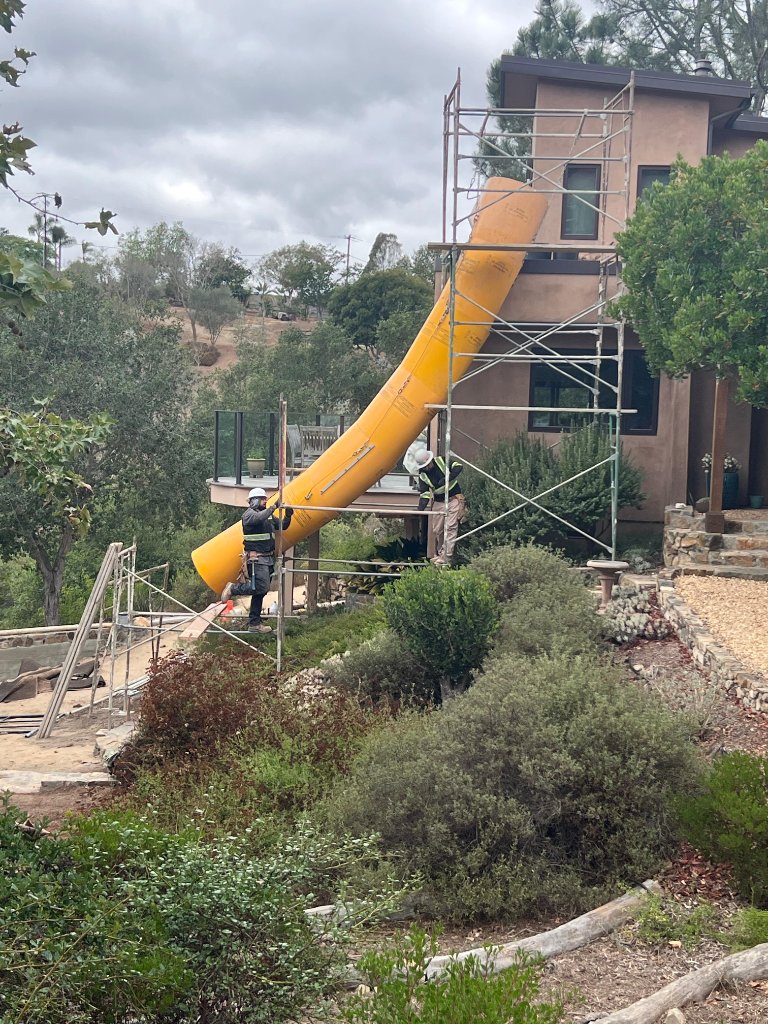 Trash chute crew installation on hillside estate - custom debris solution