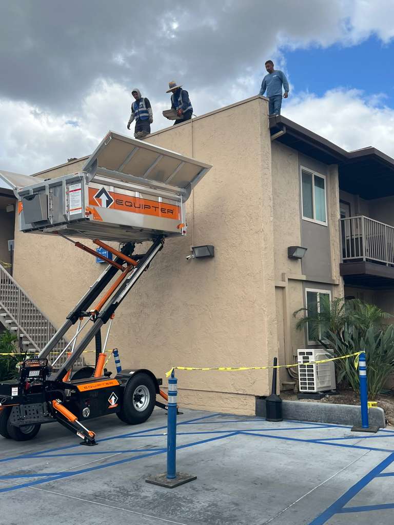 Equipter on apartment roofing job