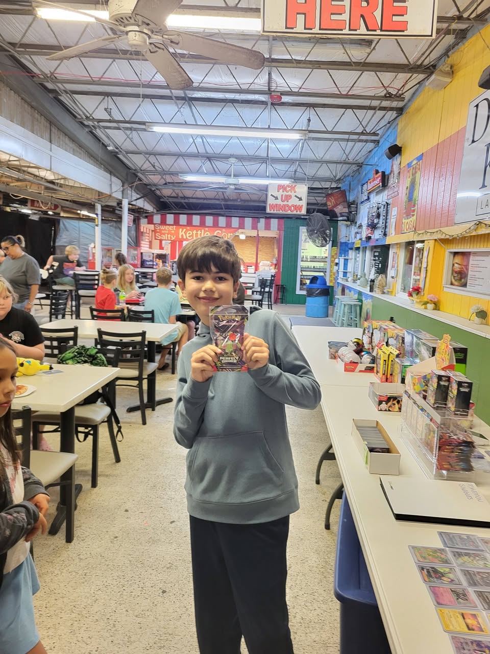 Pokekang tables full of Pokémon cards at the market