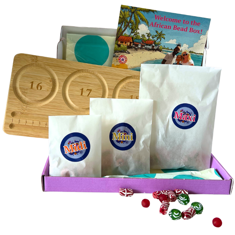 December 2025's African Bead Box, open to show colourful recycled glass beads, a welcome card and bamboo bead board, displayed on a table