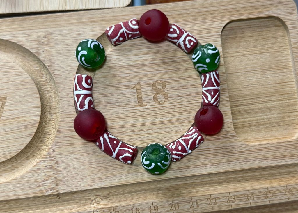 Customer creation with African beads - red, white, and green beaded bracelet