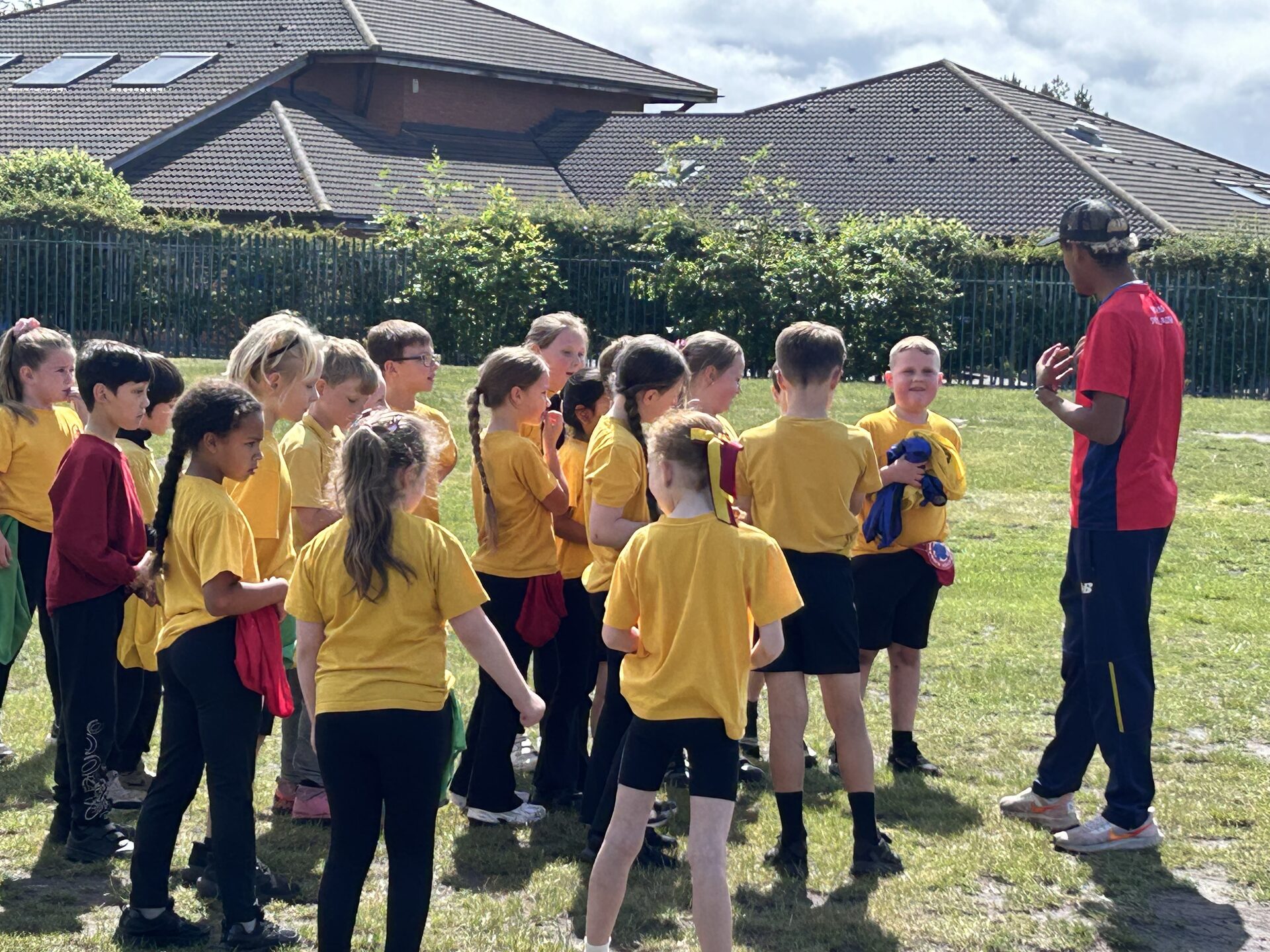 Coach leading a PE session with children at a leisure centre venue