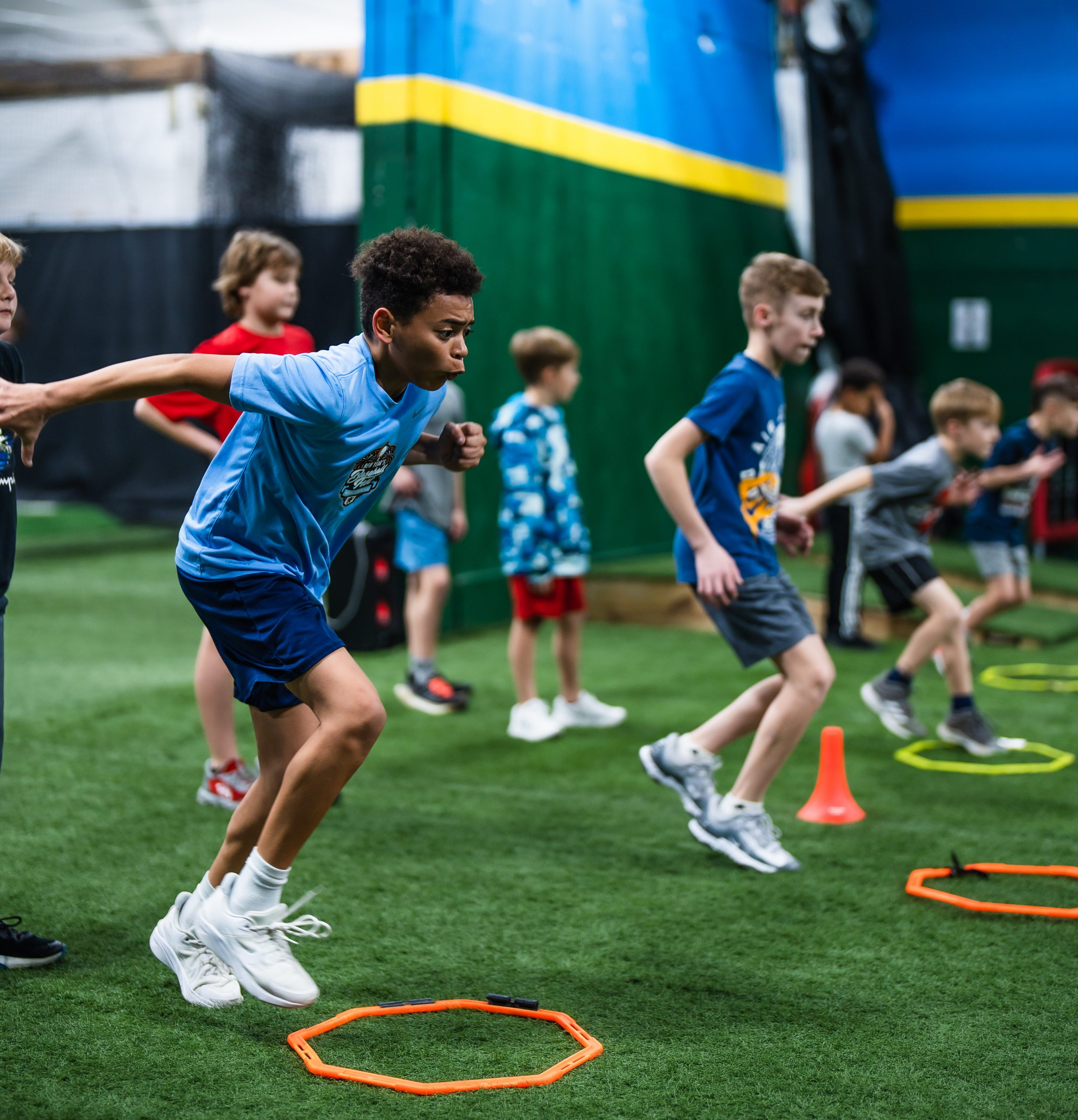 Young athletes training with agility ladders and cones