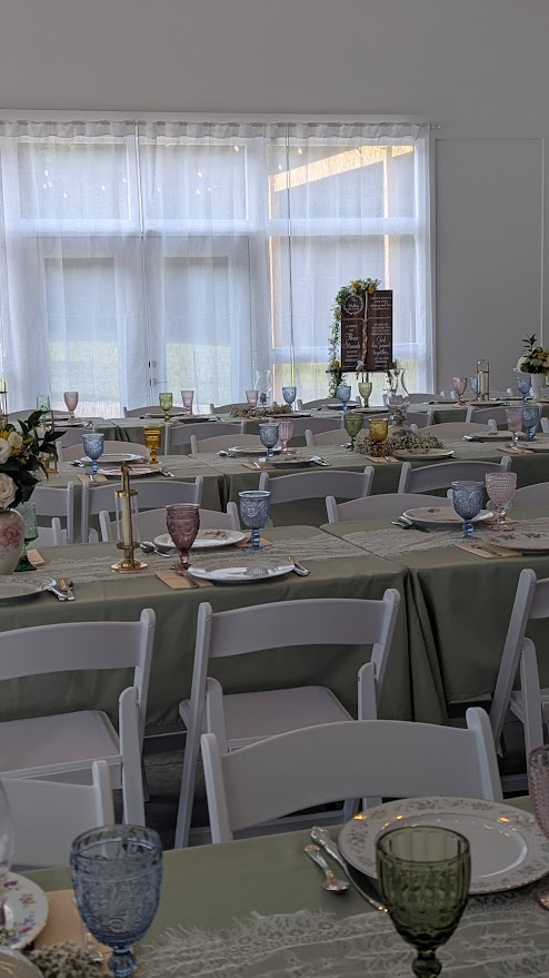 Reception tablescape with soft linens and colorful glassware