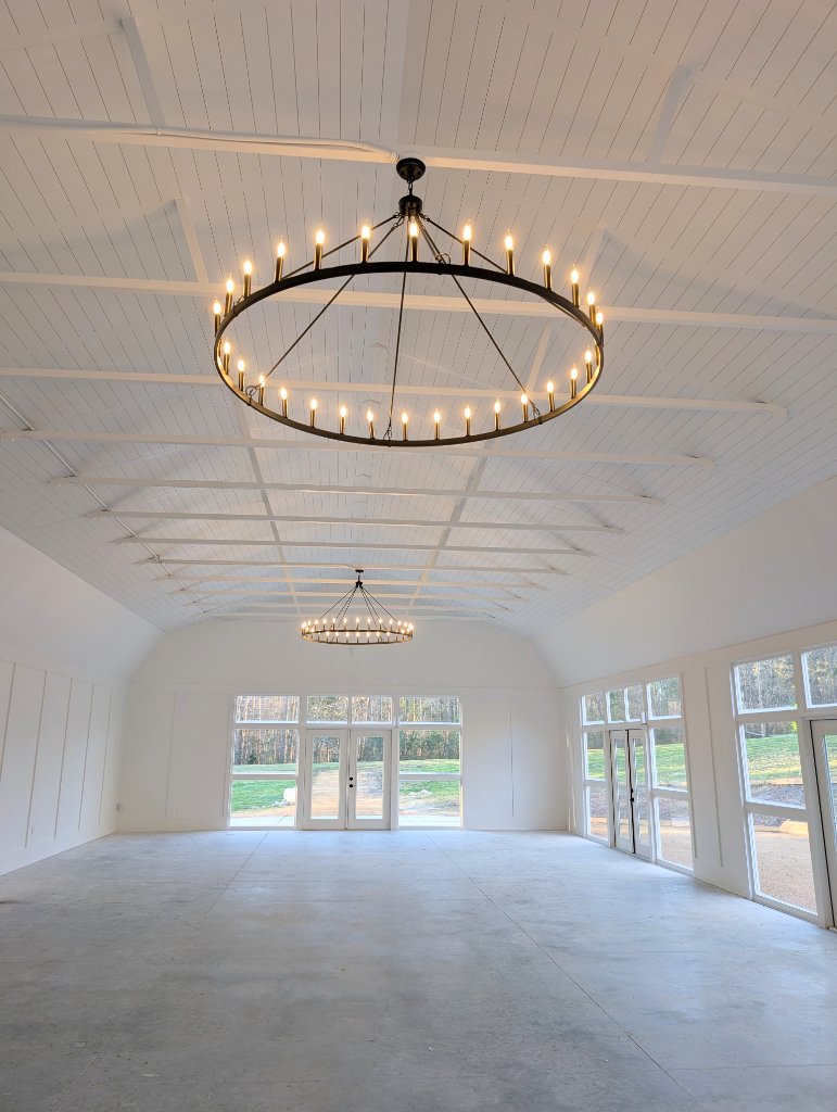 Our light-filled barn with chandeliers—an elegant setting for your day.