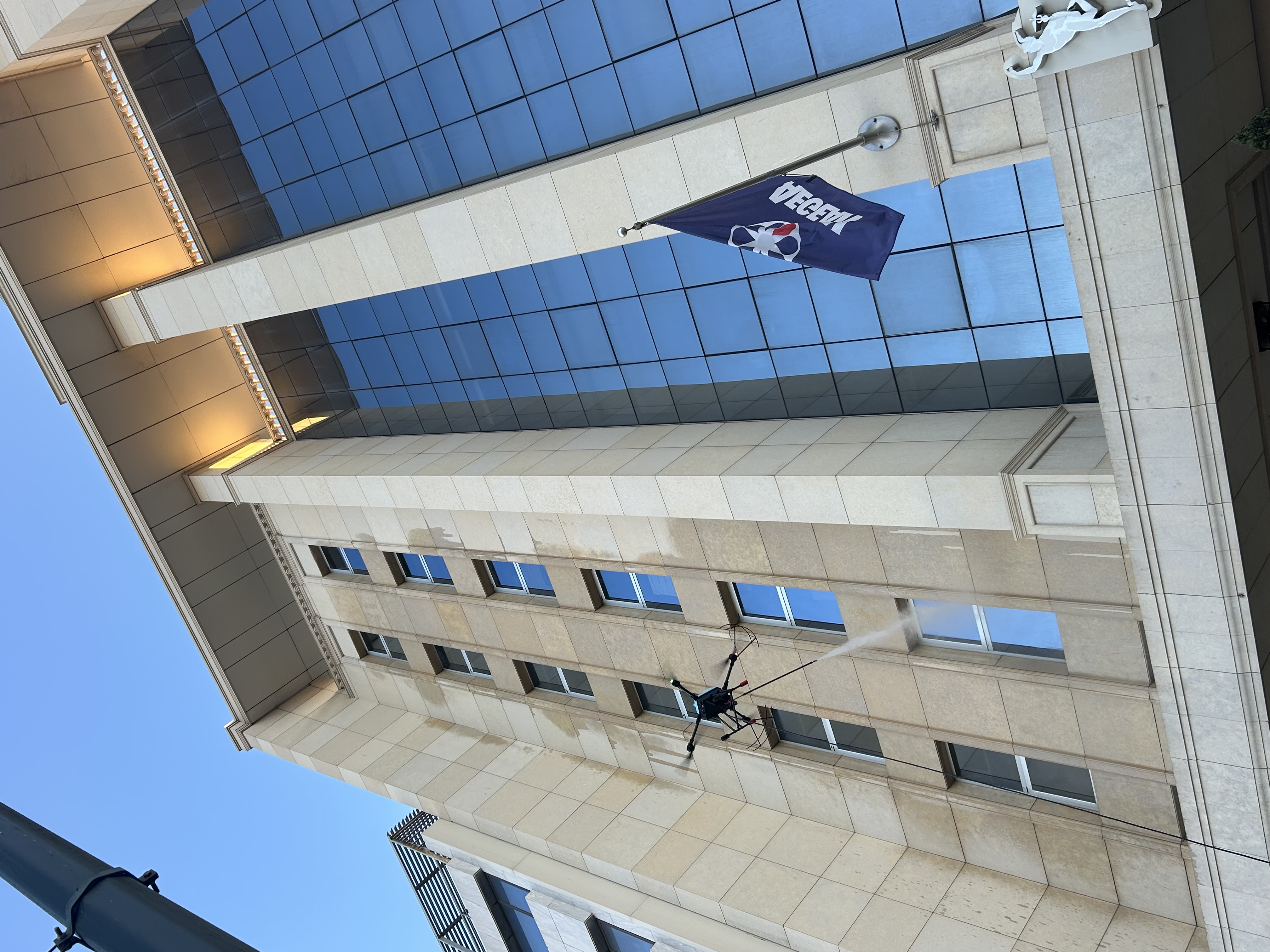 Drone cleaning an office building facade