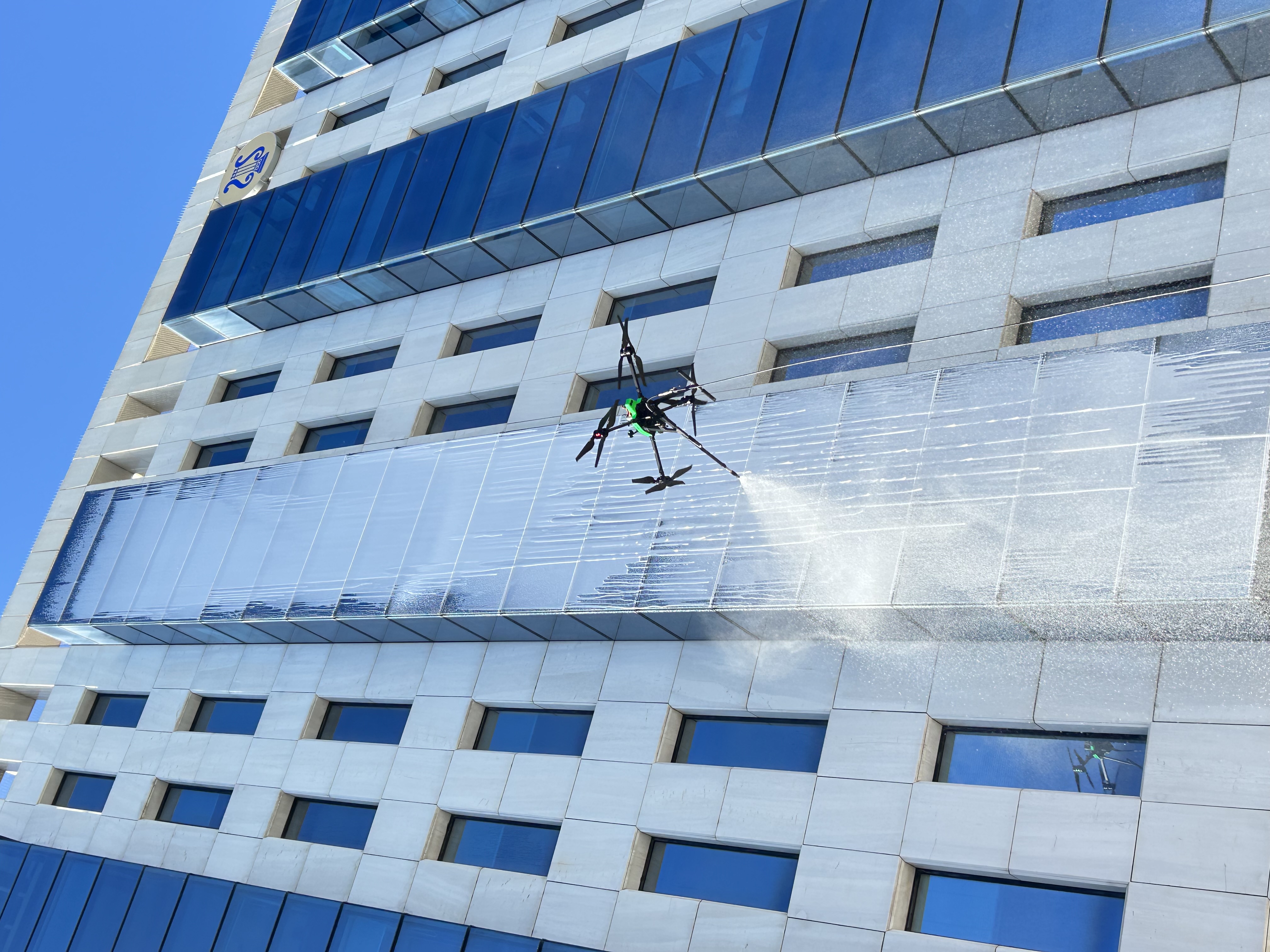 Drone cleaning a building facade