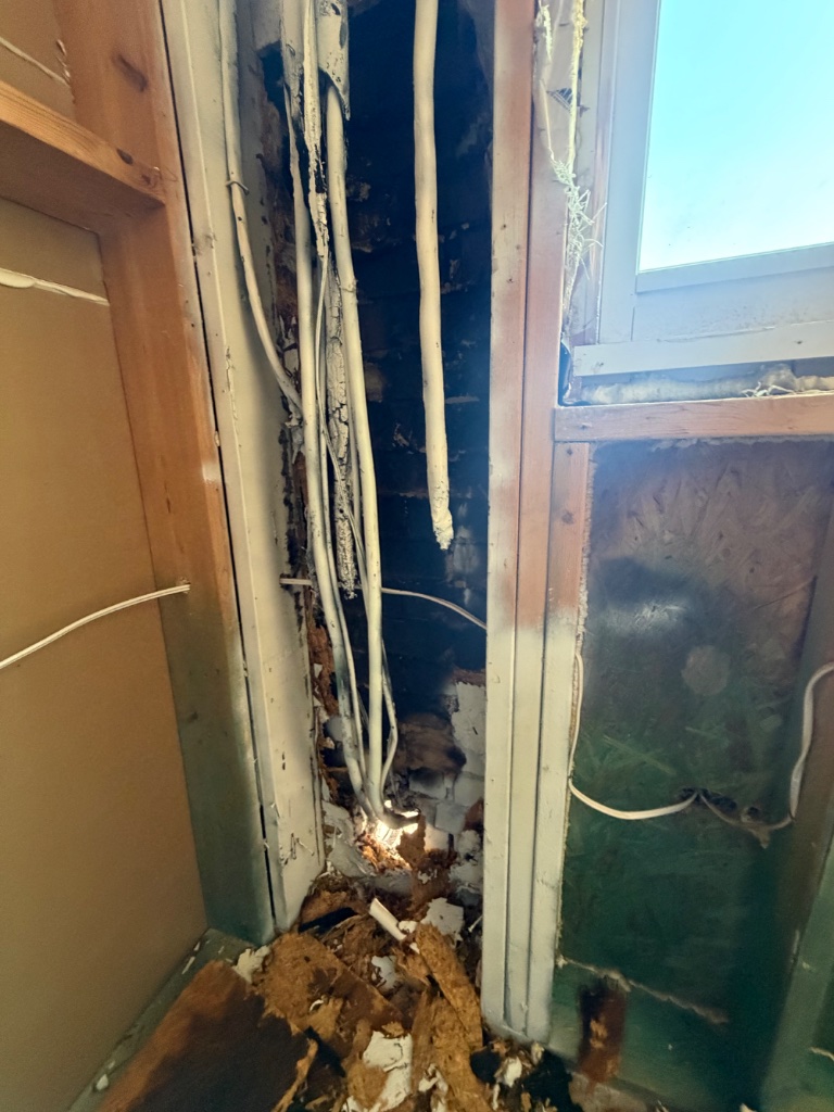 Fire damage — burned wiring and structural wall damage