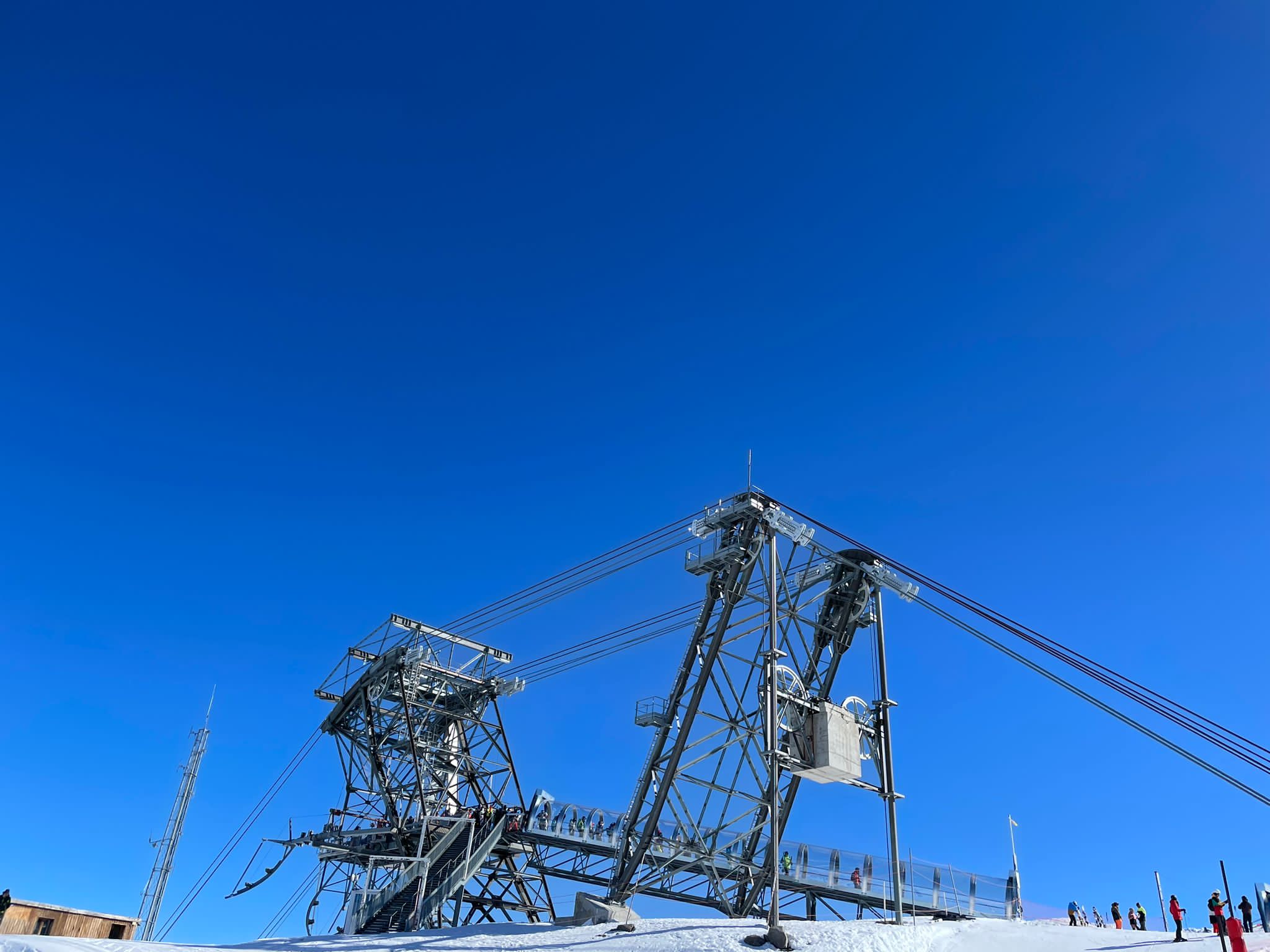 Top station of a ski lift against a deep blue sky