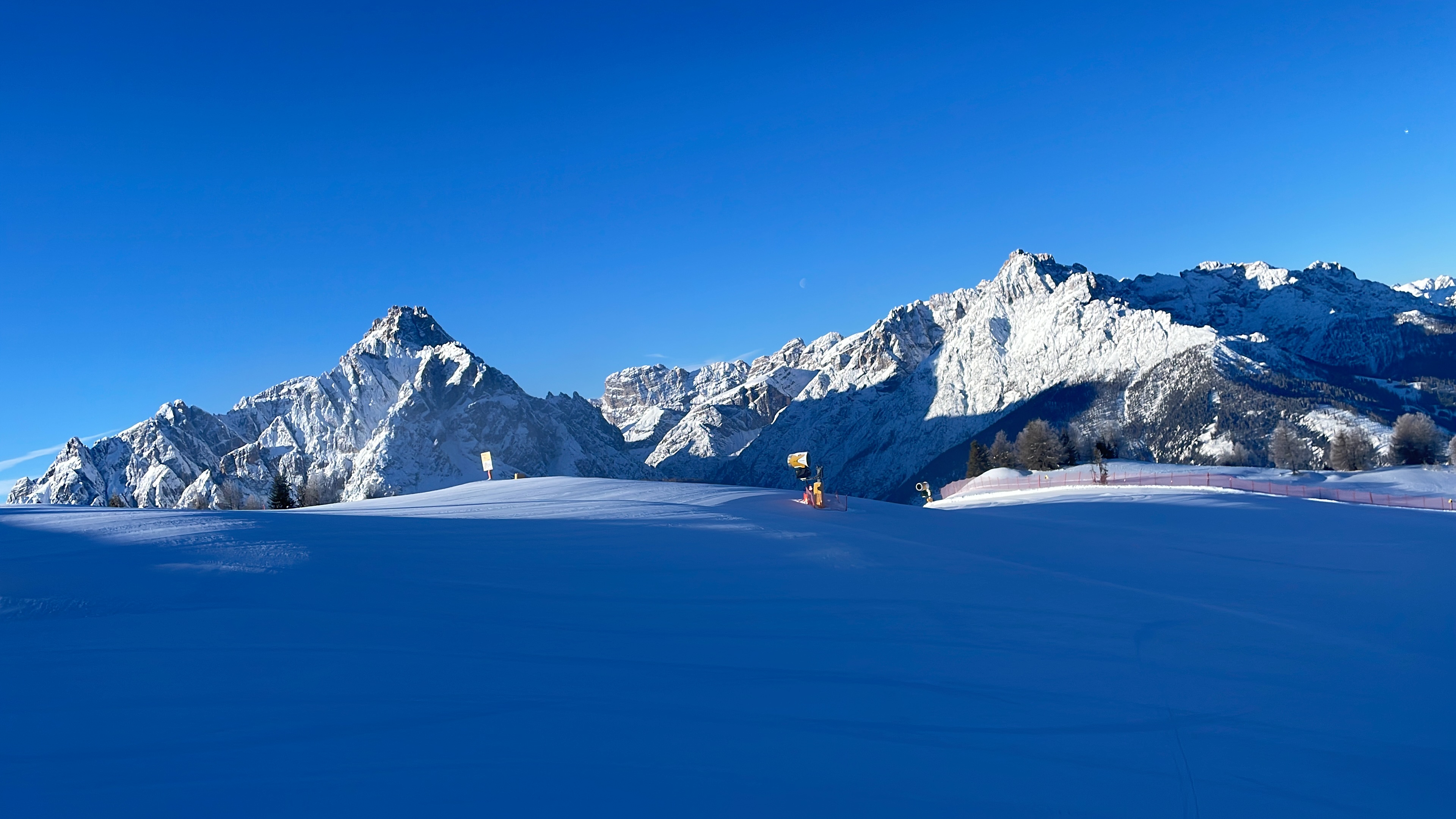 Snow-covered alpine valley with a mountain village below
