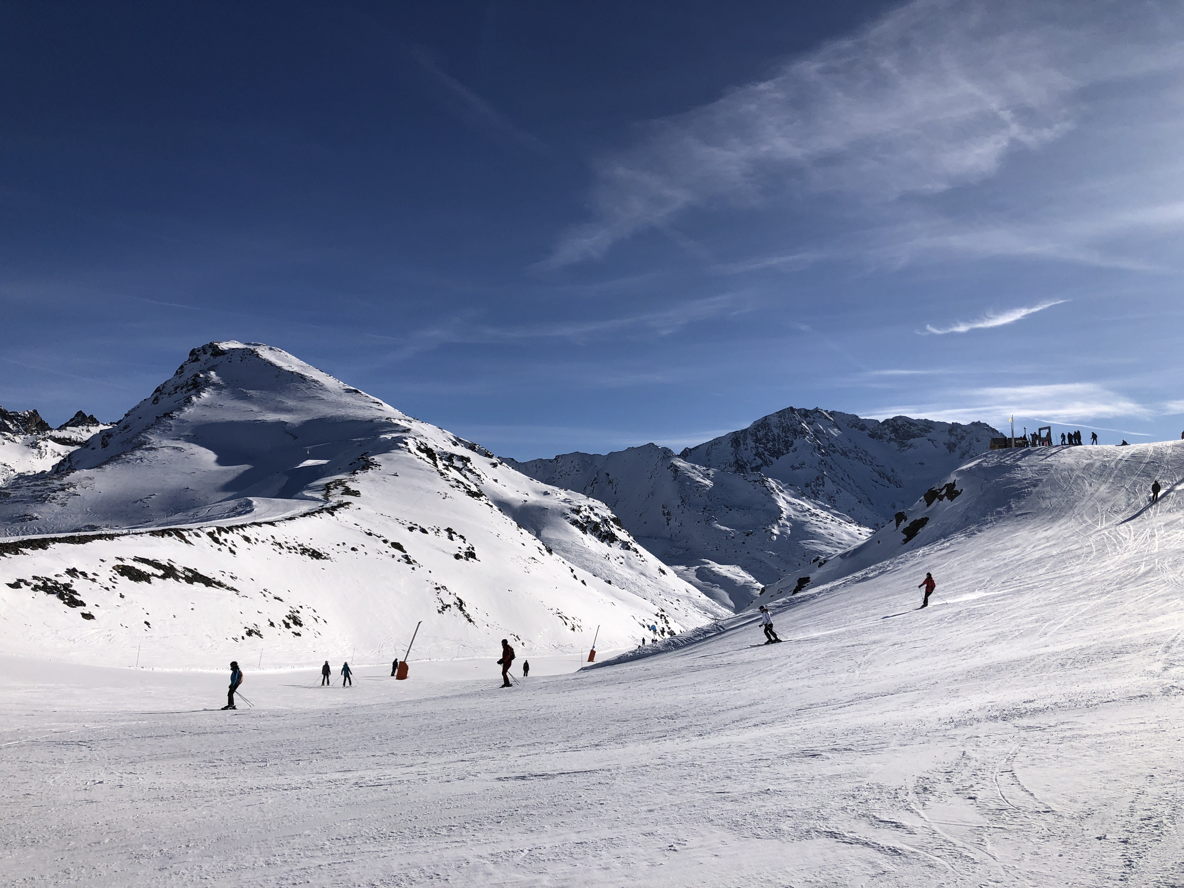 Skiers heading out across a mountain pass