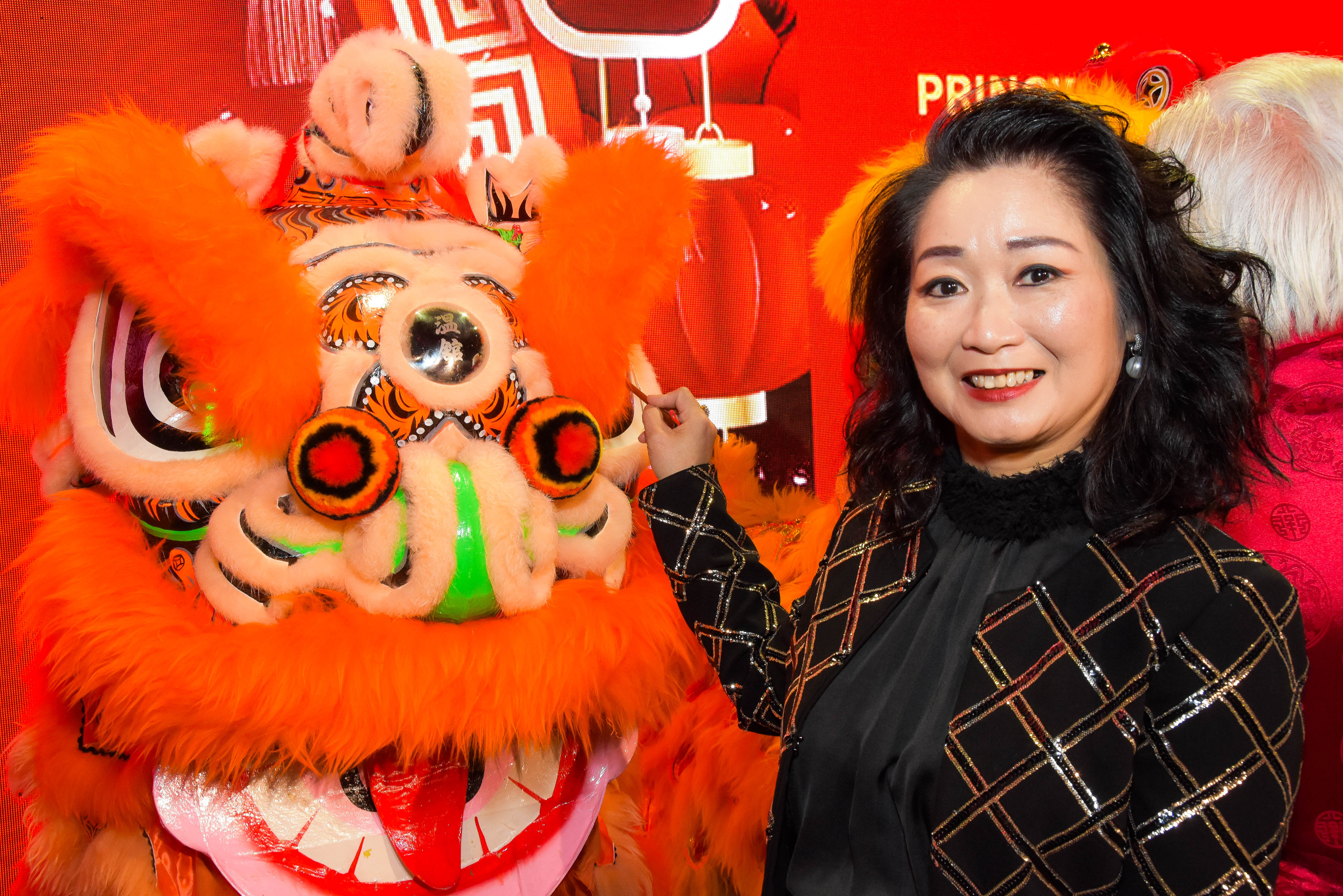 Guest performing the eye-dotting ceremony on a lion dance head at the 2026 Lunar New Year Gala