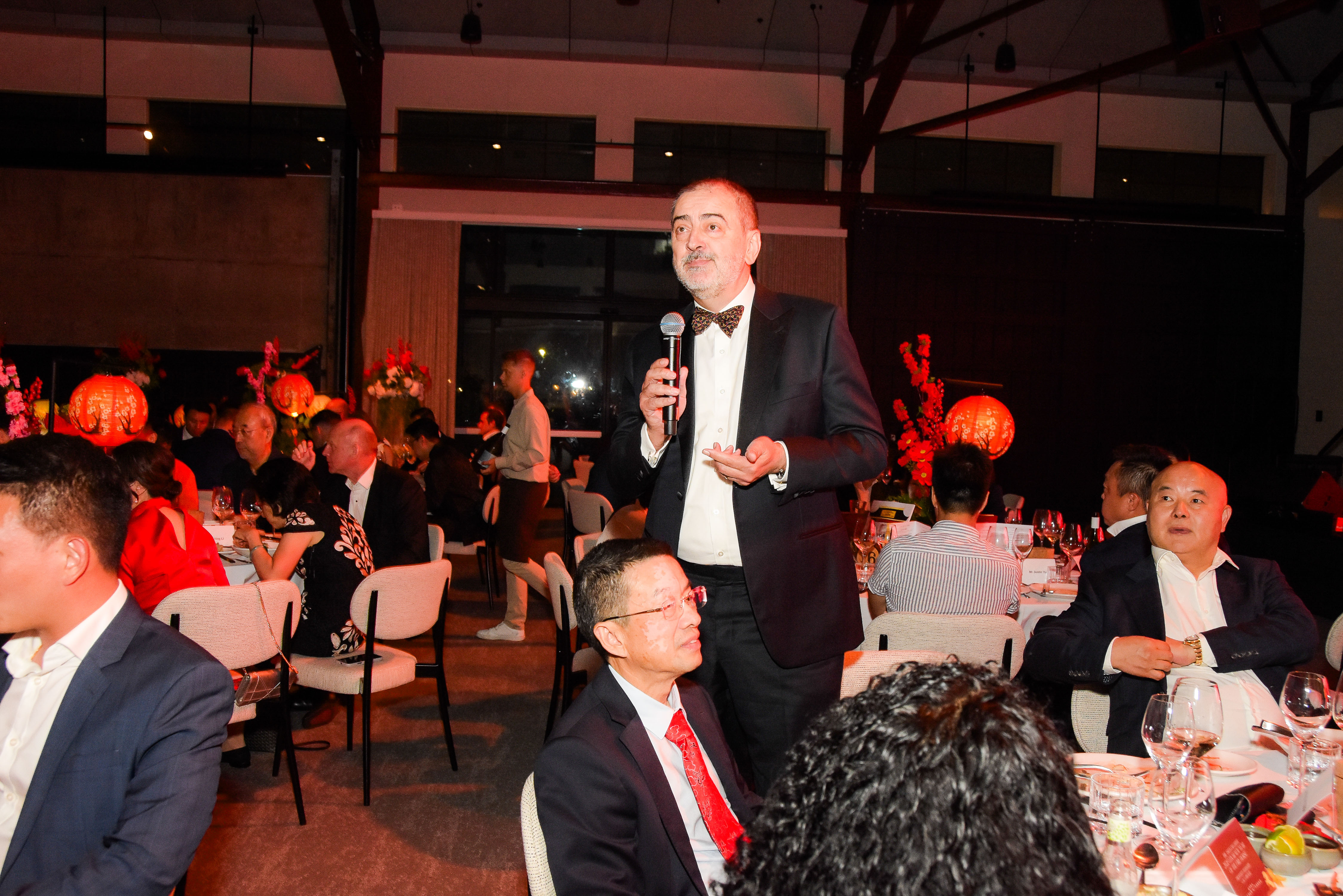 Guest in a tuxedo addressing the banquet hall during the 2026 Lunar New Year Gala