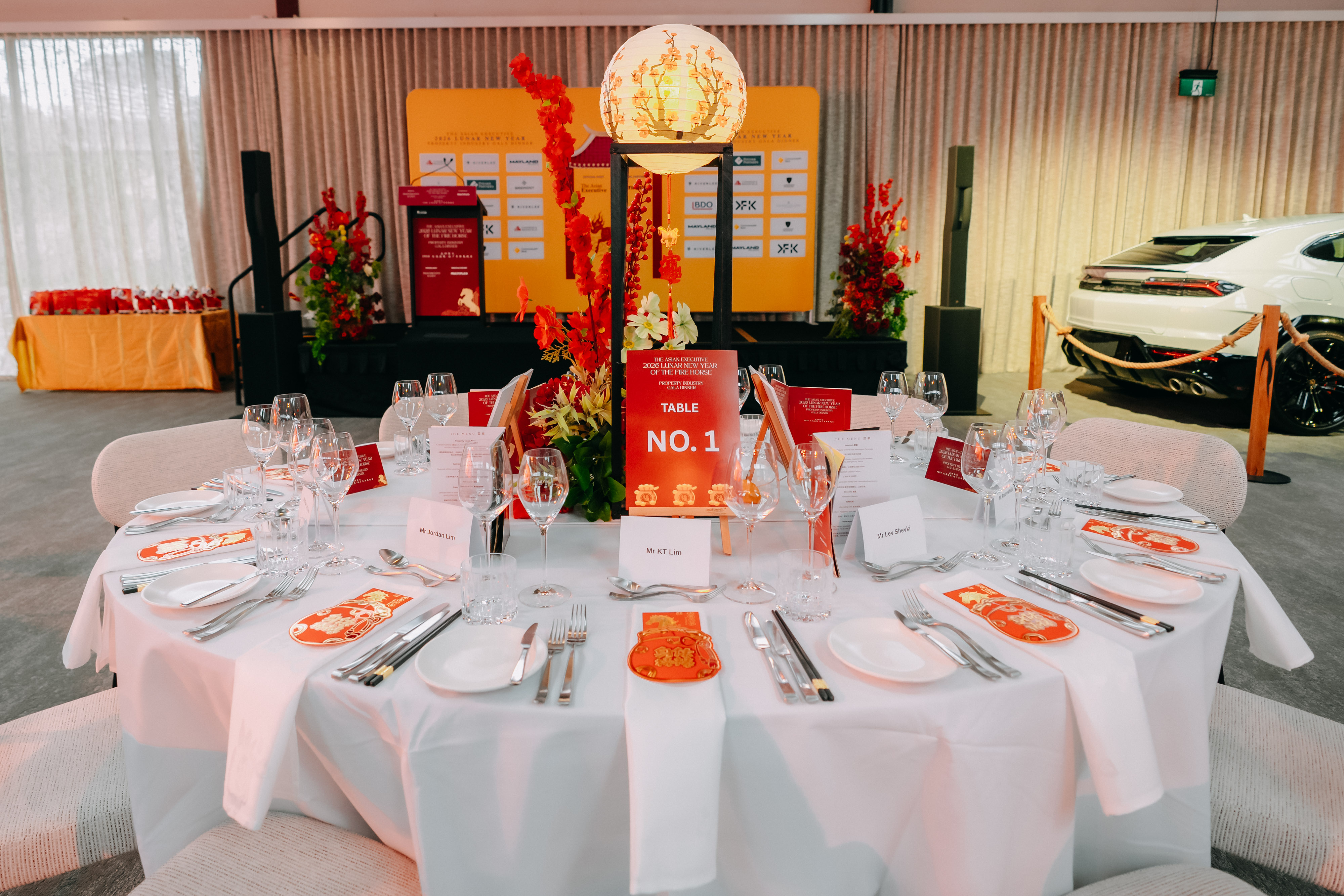 Table No. 1 place setting with red envelopes and place cards at the 2026 Lunar New Year Gala