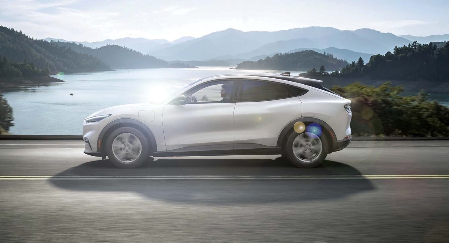 Electric car touring by a lake