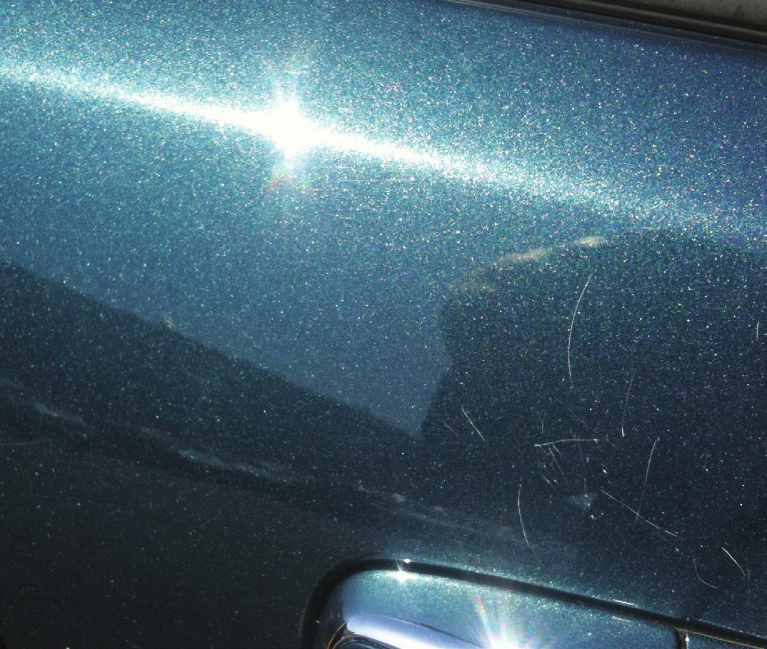 Vehicle panel before repair, with scratches