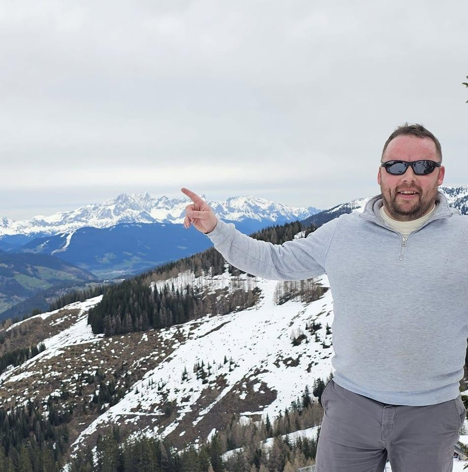 Gavin Sheppard, Senior Advisor at FleetForge, on a snowy mountain ridge
