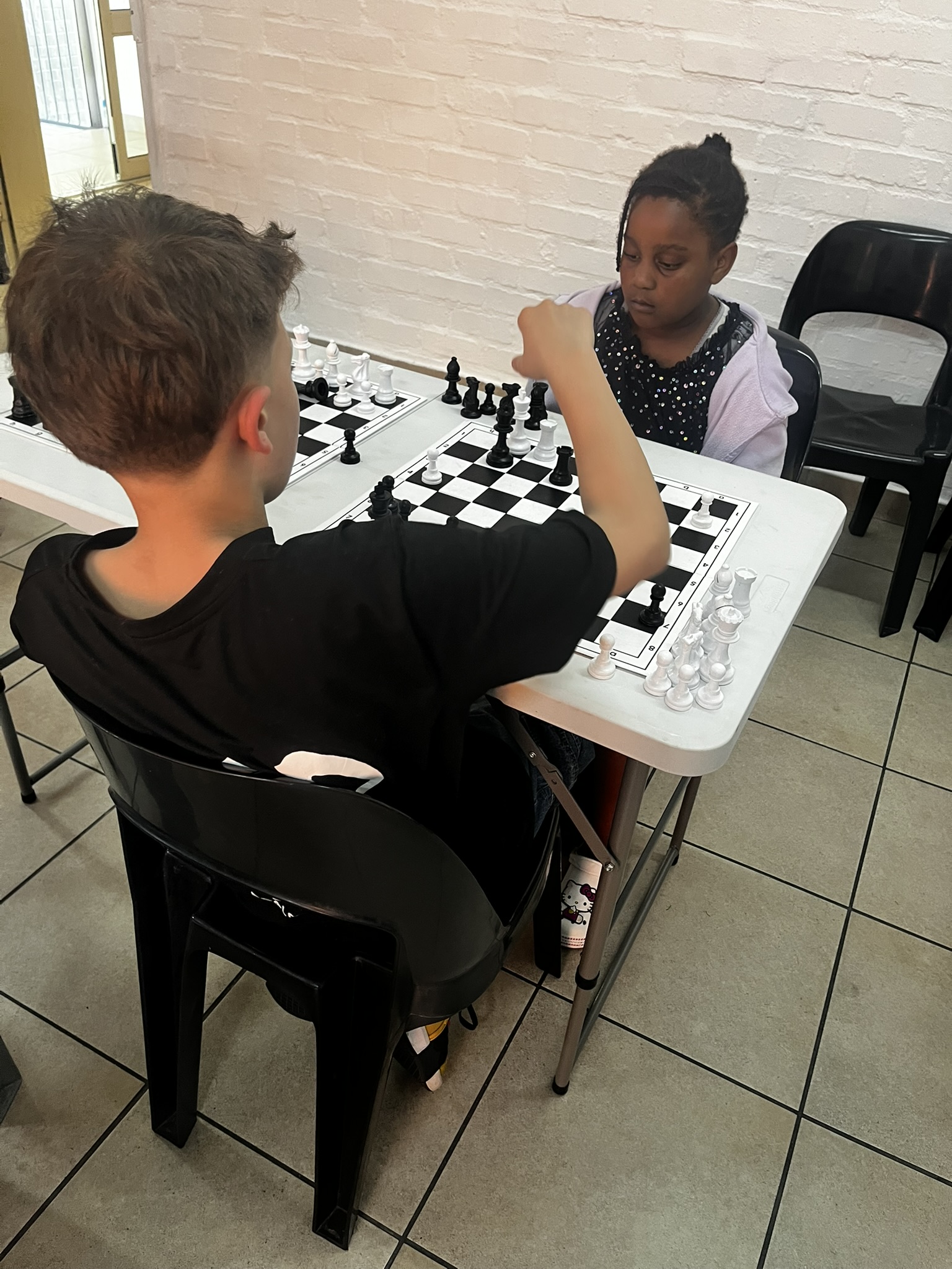 Two junior players focused intently on their game