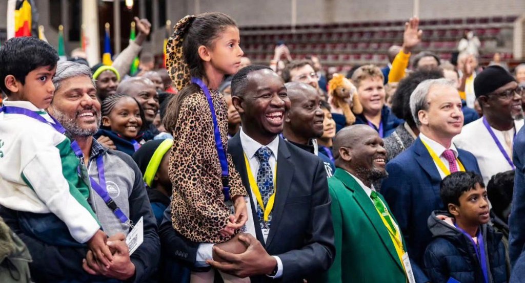Reuben Salimu with Theeran and Sophia celebrating at a chess tournament