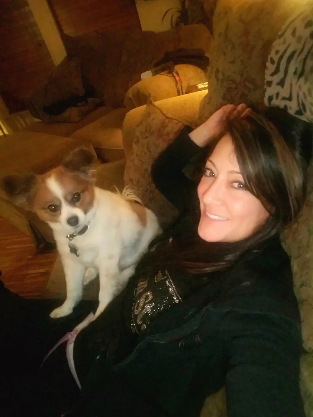 Alexa Elliot relaxing on the couch with her dog