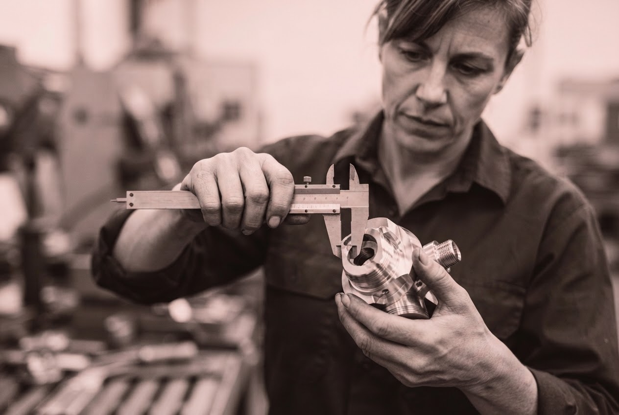 Engineer inspecting a machined part